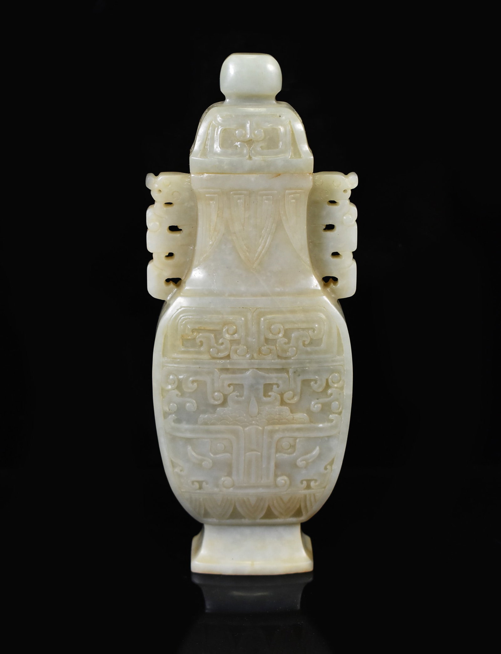 CHINESE CELADON JADE URN WITH TAOTIE MOTIF: Dimensions: 203.2mm H x 80.69mm WWeight: 500.4gSuperb carved Chinese Jade covered urn, 19th Century. Very fine nephrite jade delicately carved in form of compressed baluster shape, heavy on the lower