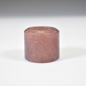 A PINK STONE ARCHERS THUMB RING