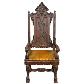 A GOTHIC REVIVAL CARVED ARM CHAIR, 19TH CENTURY