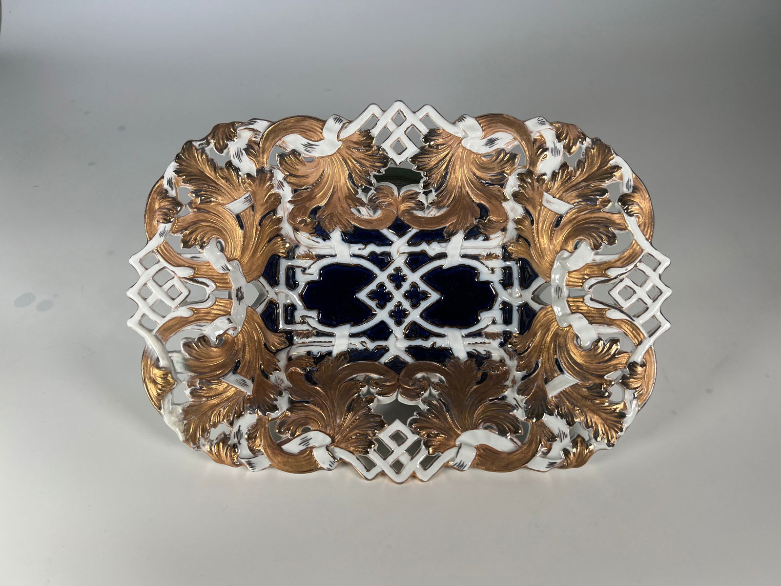 A MEISSEN PORCELAIN RETICULATED DISH, 19TH CENTURY: A MEISSEN PORCELAIN RETICULATED DISH, 19TH CENTURY marked with blue crossed swords mark Dimensions Height: 2.5" Width: 12" Depth: 8.5"