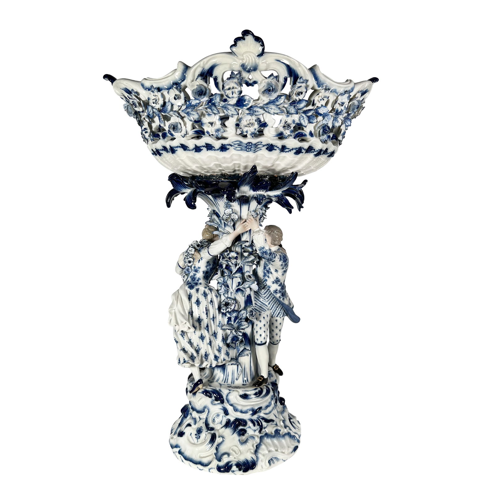 LARGE MEISSEN PORCELAIN FIGURAL BLUE CENTERPIECE, 19TH CENTURY: LARGE MEISSEN PORCELAIN BLUE FIGURAL CENTERPIECE, 19TH CENTURY the oblong pierced basket with scrolled rim and scalloped shell handles supported by a naturalistic, tree-trunk like column with