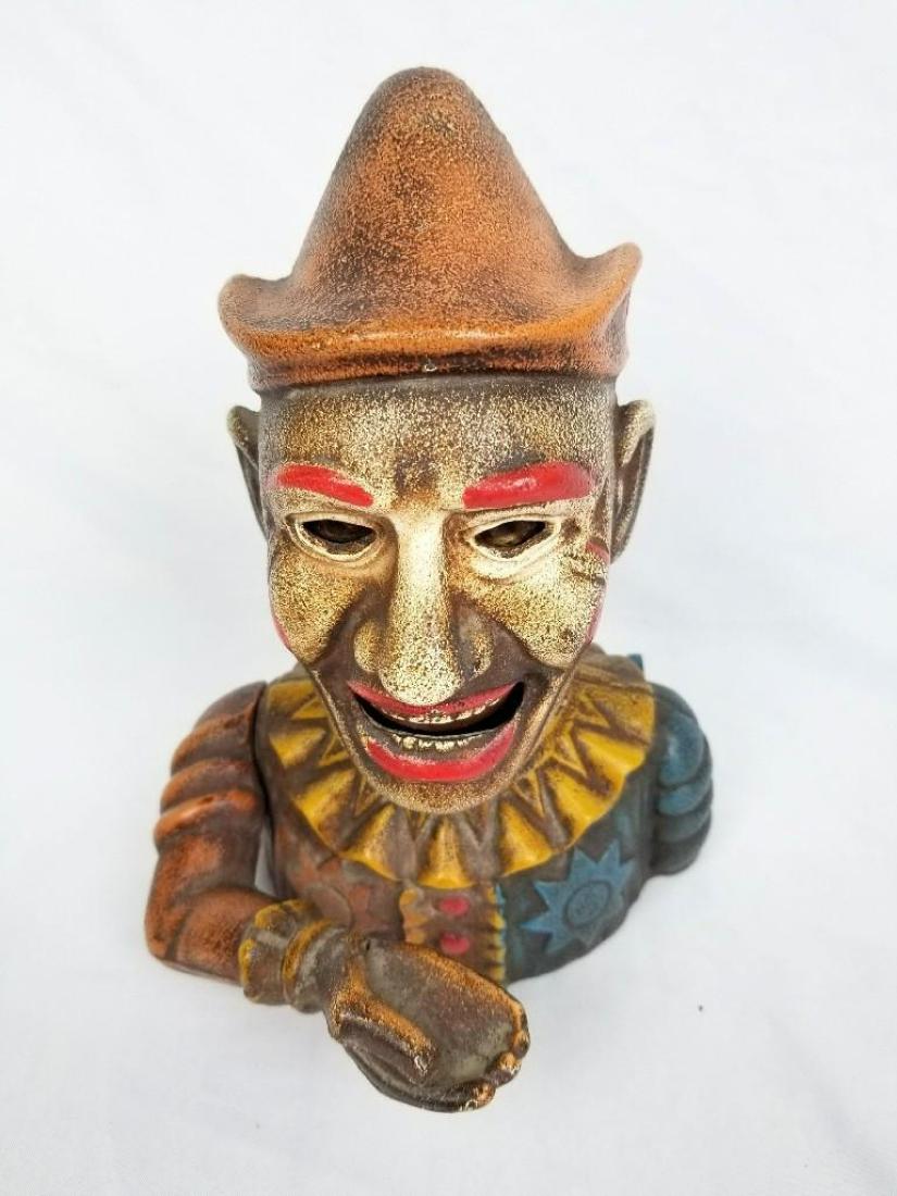 Humpty Dumpty Bank: The Humpty Dumpty bank. Place a coin in hand and depress the lever on the back, the arm will raise and he'll "eat" the coin. Recast.