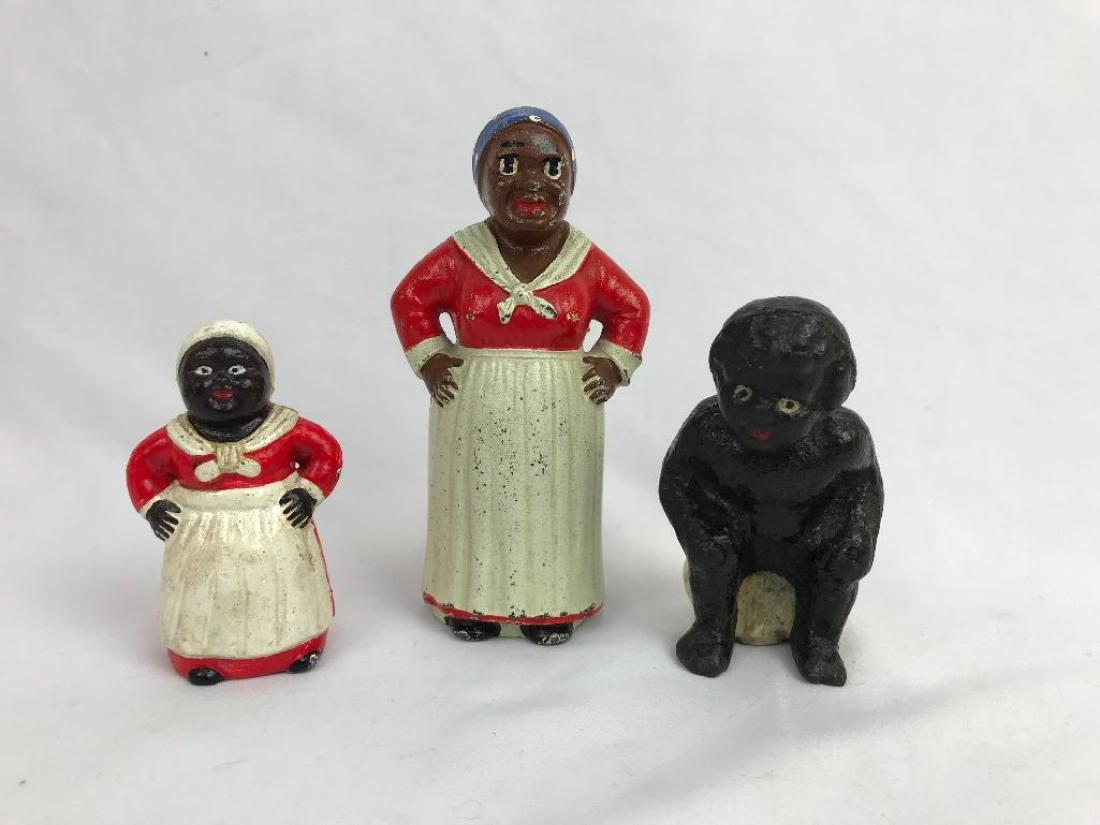 3 Cast Metal Items: Lot of three cast metal figures, Two Mammy coin banks and Baby sitting on pot. Tallest 5 1/4"