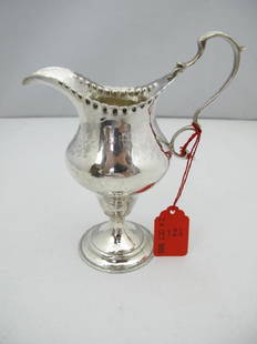 George III Hester Bateman Sterling Silver Cream Pitcher: George III Hester Bateman Sterling Silver Cream Pitcher. London, 1788 Tulip shaped on round stepped base, crimped rim, and large ear handle. Signed with hallmarks at the rim. 85 gr. H. 5 1/2 in. Sothe