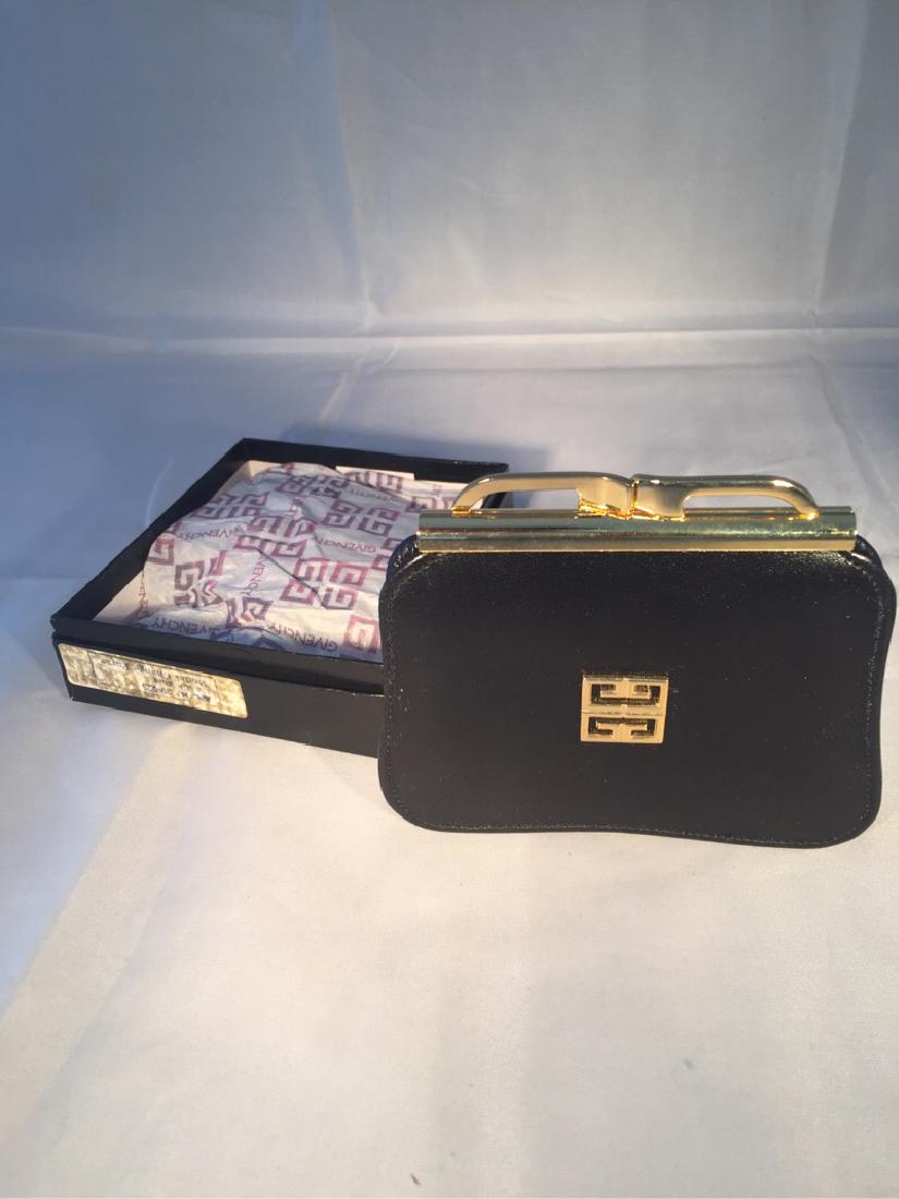 Vtg Givenchy Change Purse: Vintage Givenchy Navy Blue Change Purse Made in Spain unused. Navy blue leather coin purse measures 4 1/4" across, 3 1/2" tall and can open at the accordian type bottom as large as 1 1/4". Gold colore