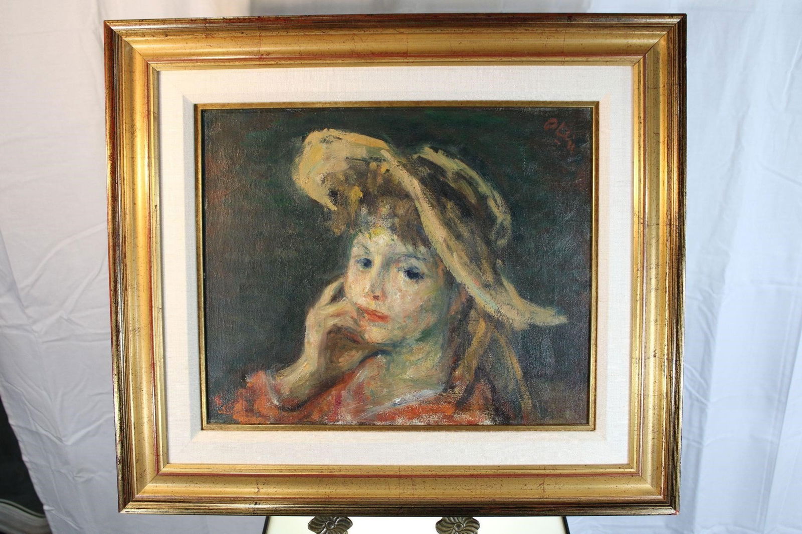 Robert Philipp Oil Painting Girl with Hat: The painting captures a young woman in a contemplative pose, her delicate features softly illuminated against a dark, muted background. Her wide brimmed hat, a cascade of earthy tones, frames her face