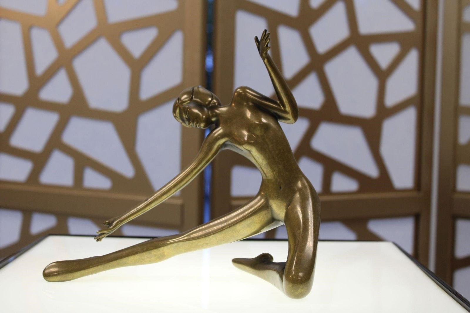Art Deco Bronze Female Figure Bob Bennett: This is a vintage Art Deco sculpture depicting a stylized female figure in a stretching pose. The piece captures the elegance and dynamic forms characteristic of the Art Deco period, emphasizing strea