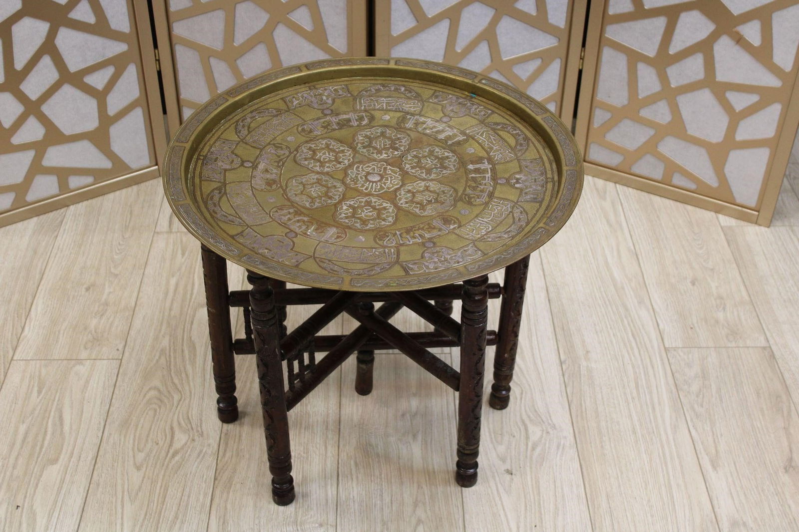 Egyptian Brass Silver Tray Table Wooden Base: These tray tables originated in the Middle East, particularly Egypt and Syria, and gained popularity during the late 19th and early 20th centuries. They were often brought back to Europe and America a