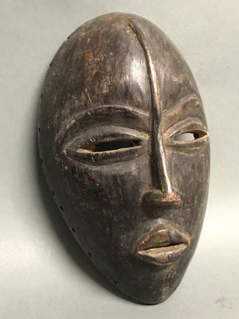 Dan Mask: African Art Dan Mask from Ivory Coast. The dimension 9.5 inches high x 6 inches wide. The packing and shipping cost with insurance for domestic is $30.00 flat rate shipping within the Continental US, 