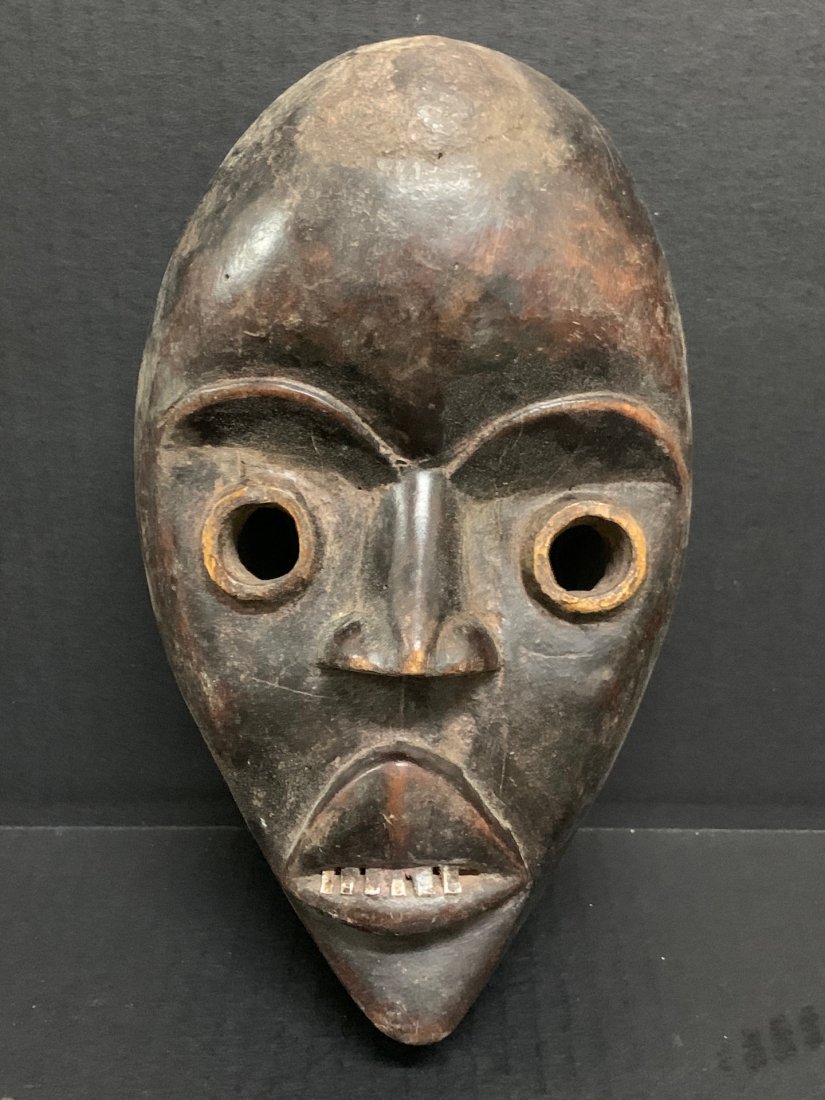 Dan Mask: African Tribal Art Dan Mask from Ivory Coast. The dimension 9.5 inches high x 5.5 inches wide. The packing and shipping cost with insurance for domestic is $35.00 flat rate shipping within the Contine