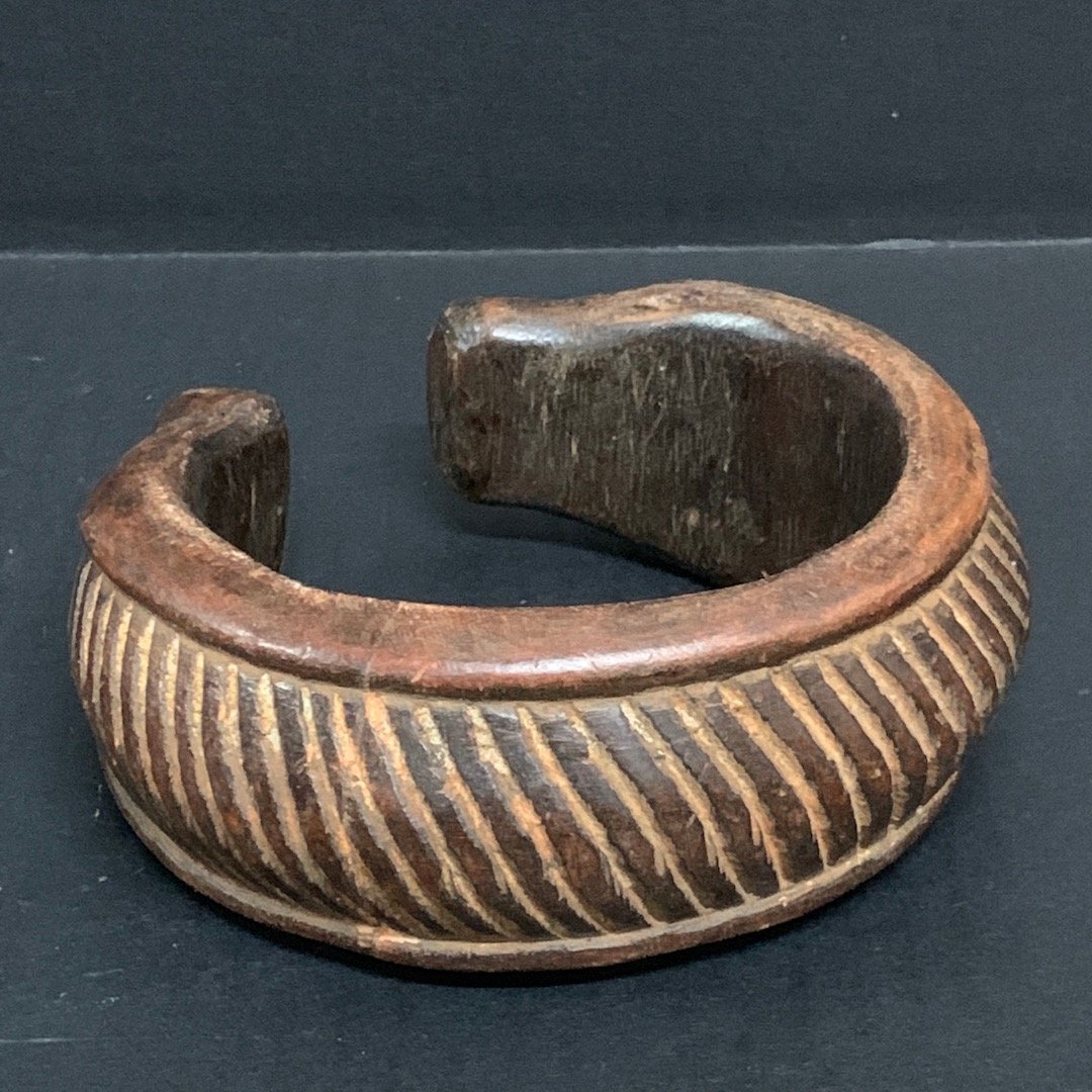 Wood Nigerian Currency Bracelet: African Art, Tribal art Nigerian Currency Bracelet from Nigeria. The dimension is 5 inches high x 2.5 inches wide. The shipping cost for domestic is $25.00 flat rate shipping within the Continental US