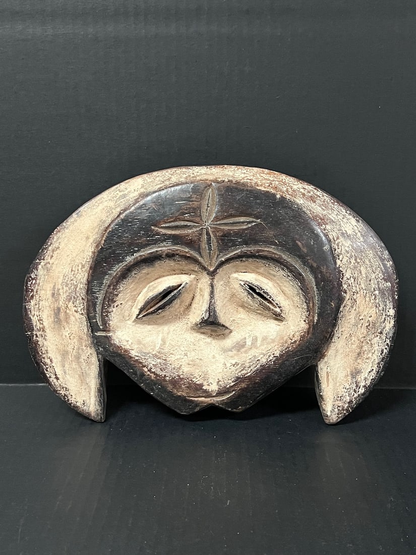 Kwele Mask: African Tribal Art Kwele Mask. The dimension is 8 inches high x 12 inches wide. The shipping cost for domestic is $30.00 flat rate shipping within the Continental US including handling, packing and in