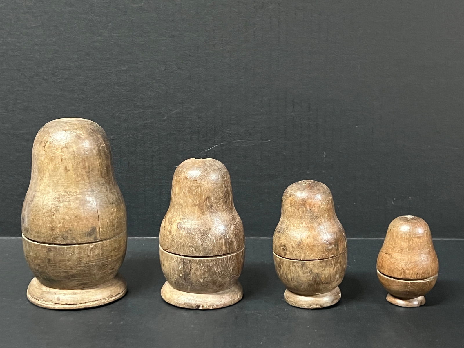 Carved Wood Nesting Doll Sculpture 4 pieces: Decorative Folk Art Papermache Mold of Nesting Doll. The dimension is 6 inches high x 3.5 inches wide, 4.75 inches high x 2.75 inches wide, 3 inches high x 2 inches wide and 4 inches high x 2.5 inches