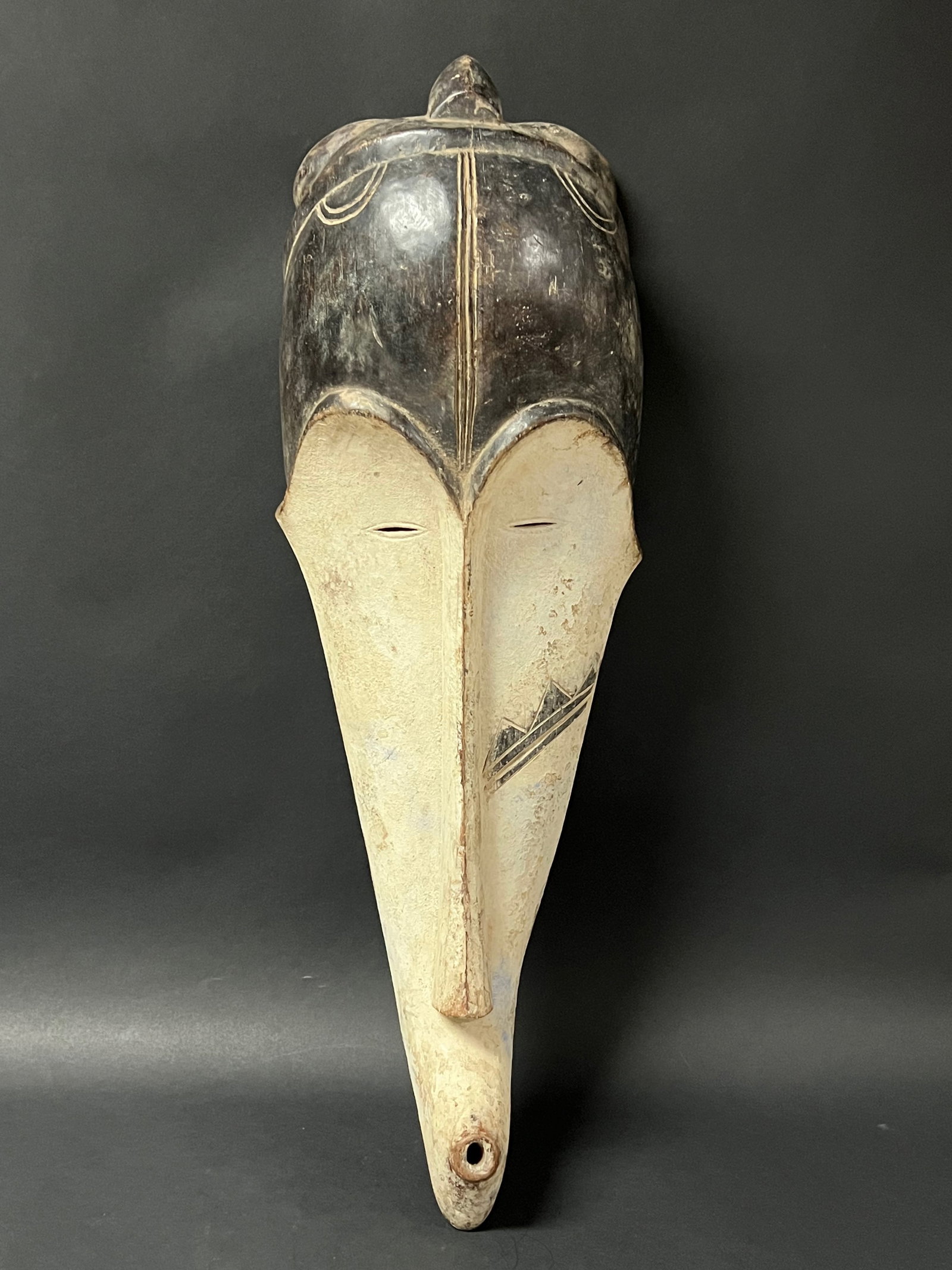 Fang Mask: African Tribal Art Fang Mask. The dimension is 23 inches high x 5.5 inches wide. Please be aware that some of the items are vintage, secondhand, old ages, antiques and may have a defects or sign of ag