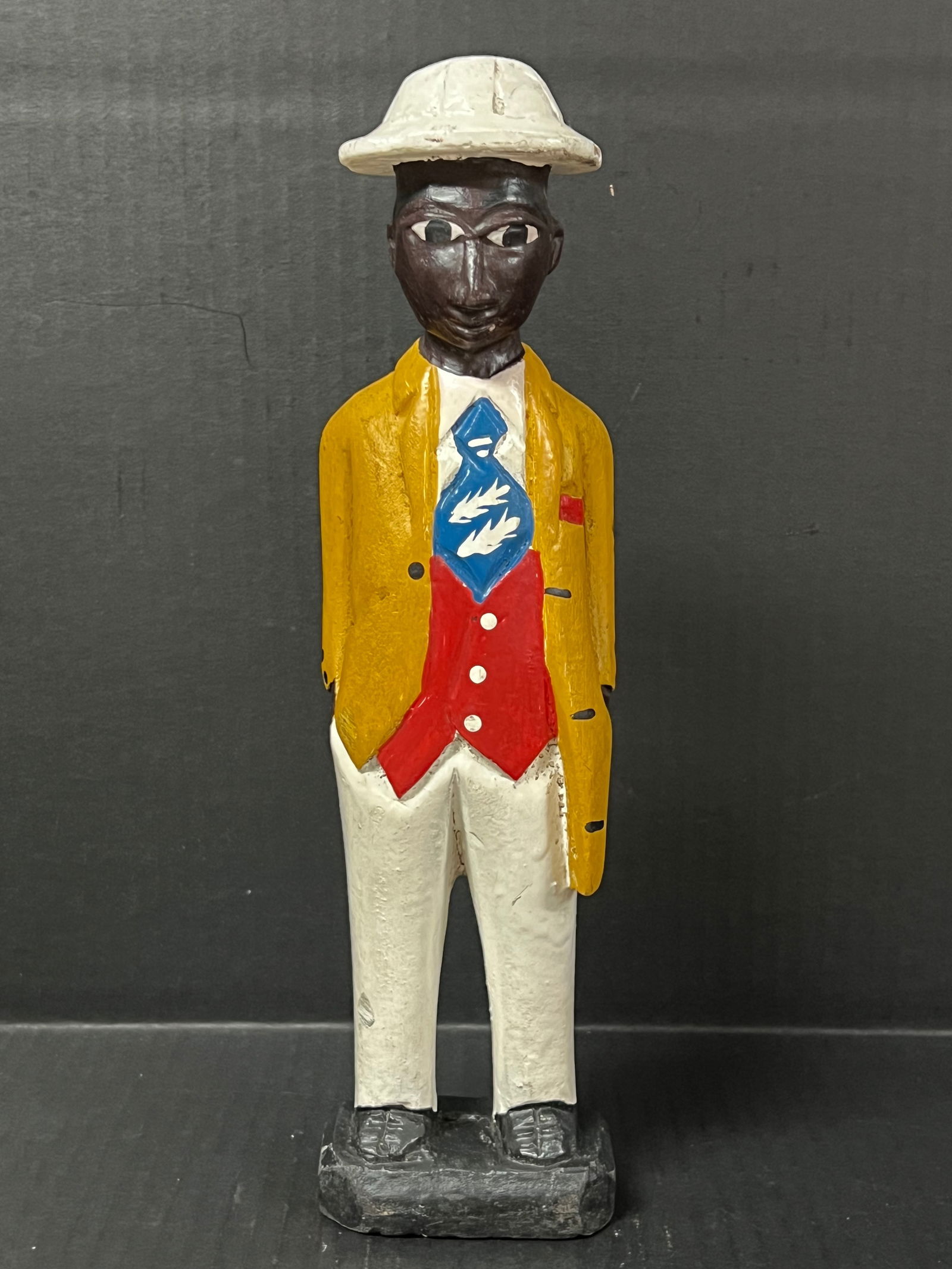 Colonial Statue: African Art Colonial Statue. The dimension is 12 inches high x 3 inches wide. Please be aware that some of the items are vintage, secondhand, old ages, antiques and may have a defects or sign of ages,