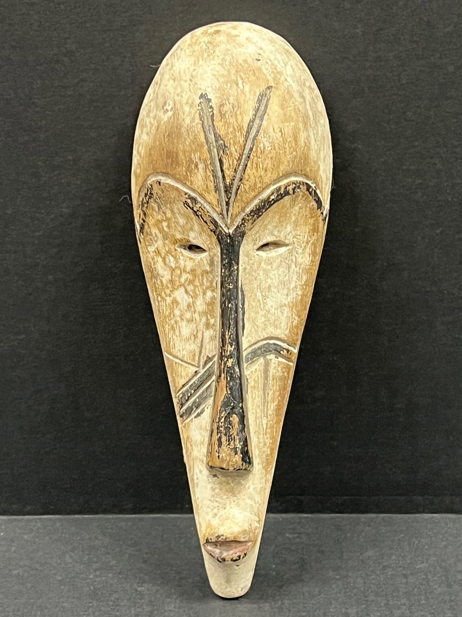 African Art Carved Wood Mask: African Art Carved Wood Mask. The dimension is 7.5 inches high x 3 inches wide. Please be aware that some of the items are vintage, secondhand, old ages, antiques and may have a defects or sign of age