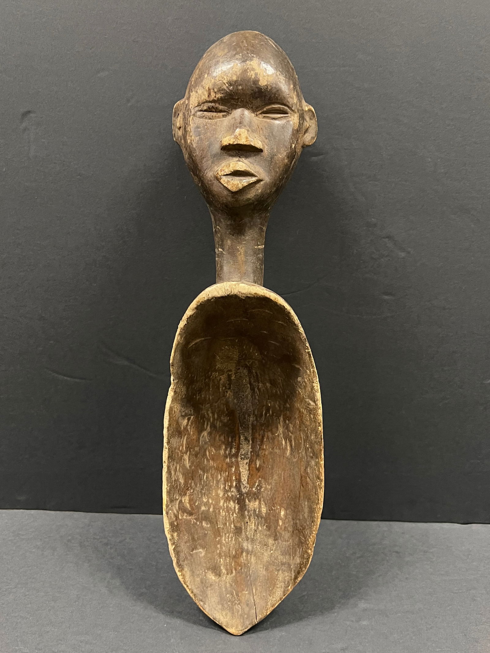 Dan Wooden Spoon: African Tribal Art Carved Wood Dan Wooden Spoon. The dimension is 17.5 inches high x 5 inches wide. Please be aware that some of the items are vintage, secondhand, old ages, antiques and may have a