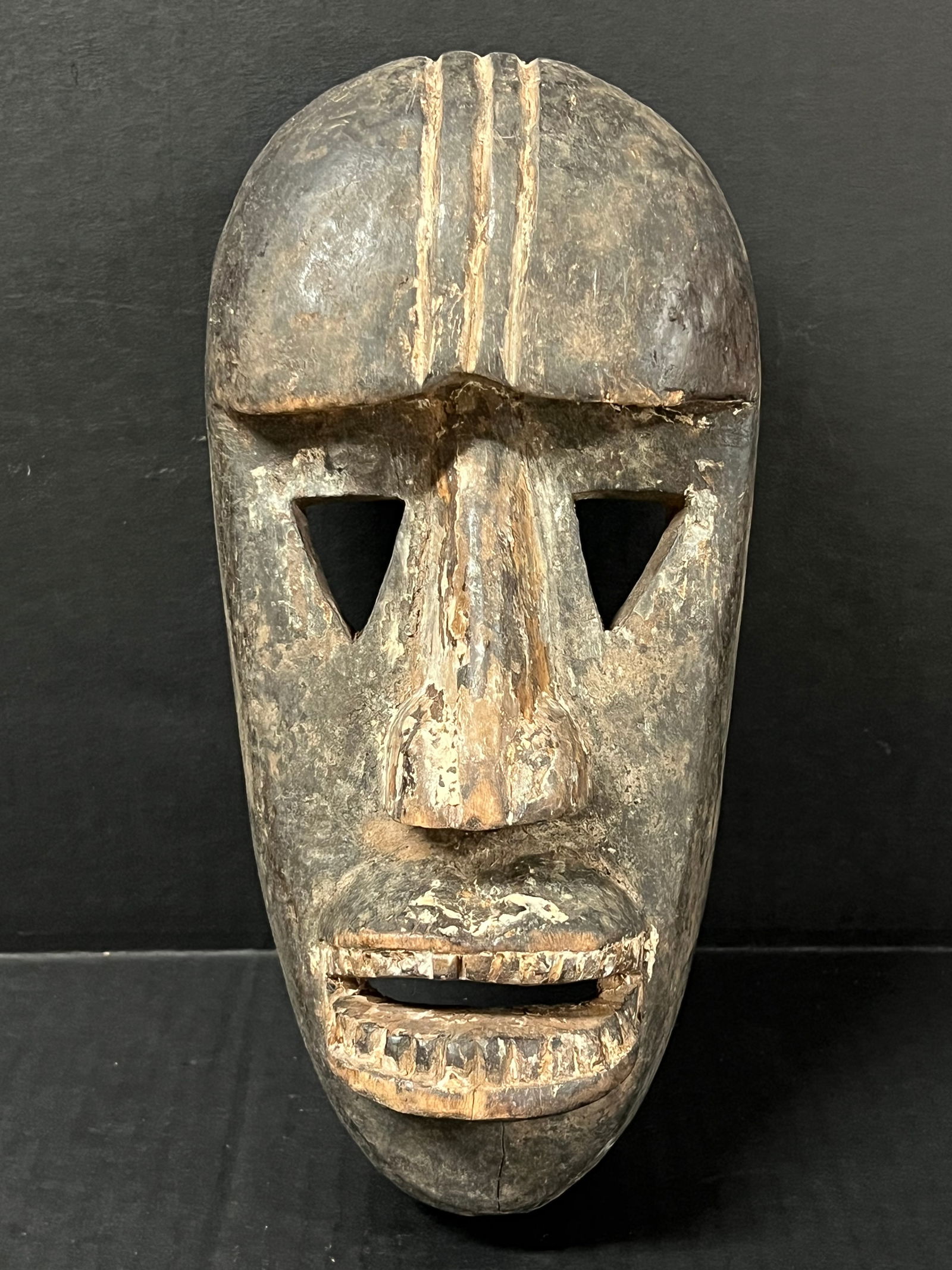 Dan Mask: African Tribal Art Carved Wood Kwele Mask. The dimension is 10.75 inches high x 5 inches wide. Please be aware that some of the items are vintage, secondhand, old ages, antiques and may have a