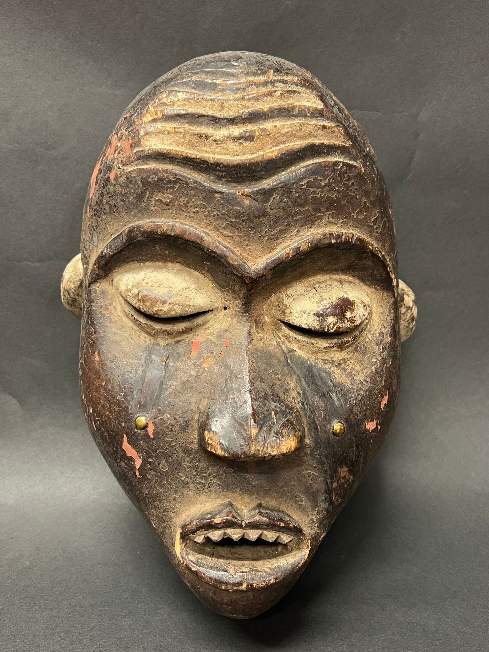 Bacongo Mask: African Tribal Art Carved Wood Bacongo Mask. The dimension is 12 inches high x 8 inches wide. Please be aware that some of the items are vintage, secondhand, old ages, antiques and may have a defects
