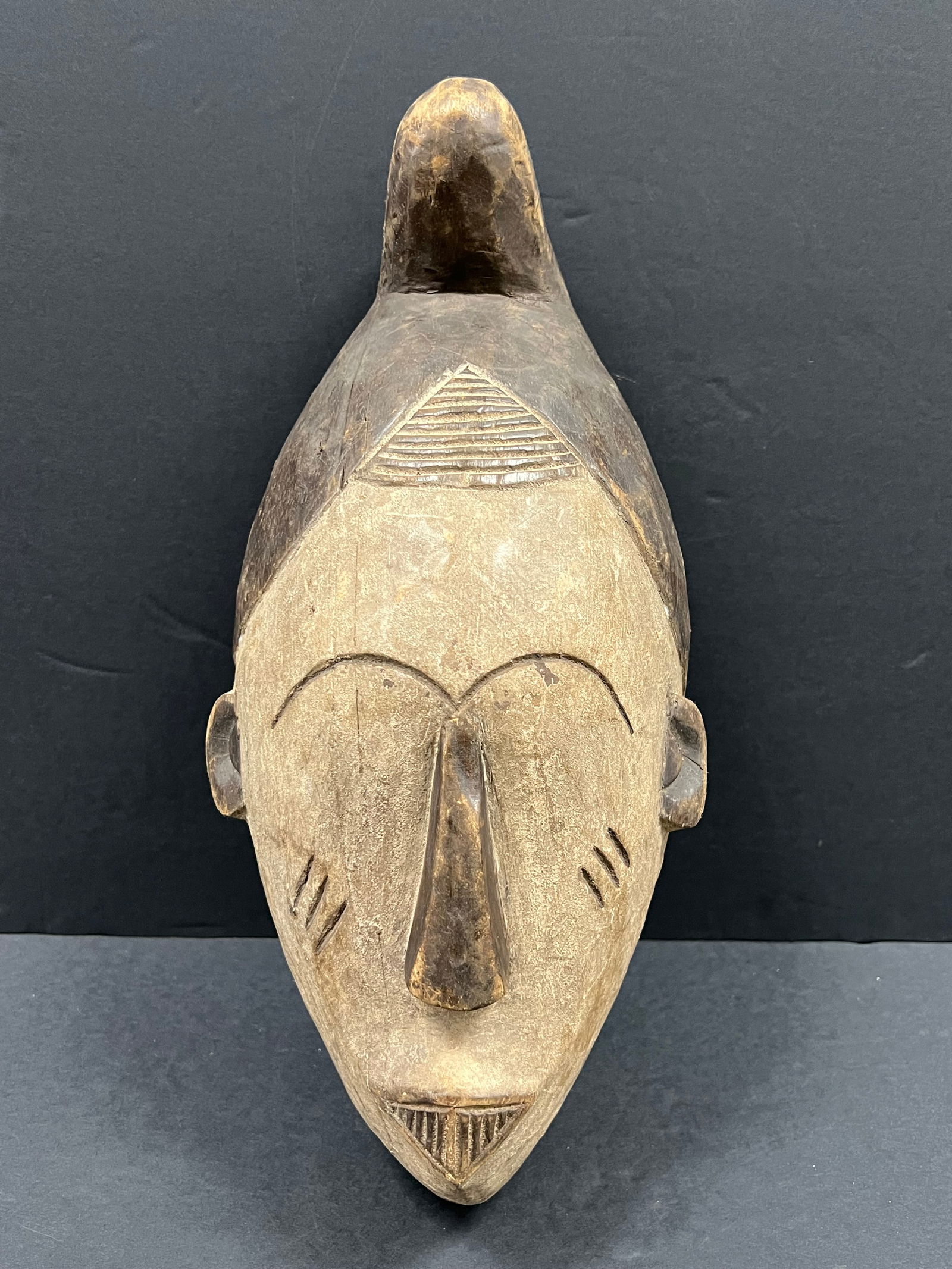 Ibo Mask: African Tribal Art Carved Wood Ibo Mask. The dimension is 16 inches high x 8 inches wide. Please be aware that some of the items are vintage, secondhand, old ages, antiques and may have a defects or