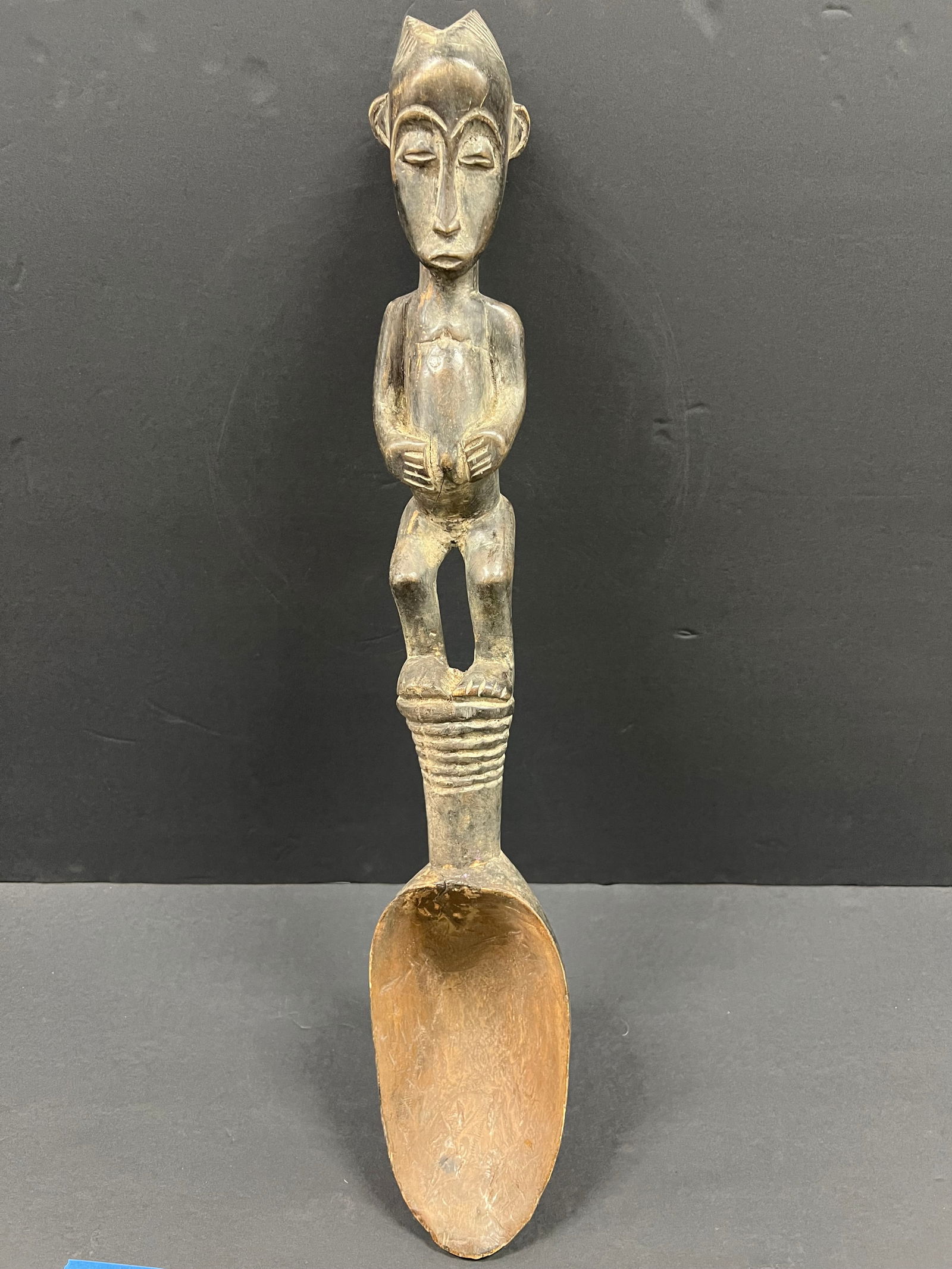 Baule Wooden Spoon: African Tribal Art Carved Wood Baule Spoon. The dimension is 26 inches high x 4.5 inches wide. Please be aware that some of the items are vintage, secondhand, old ages, antiques and may have a