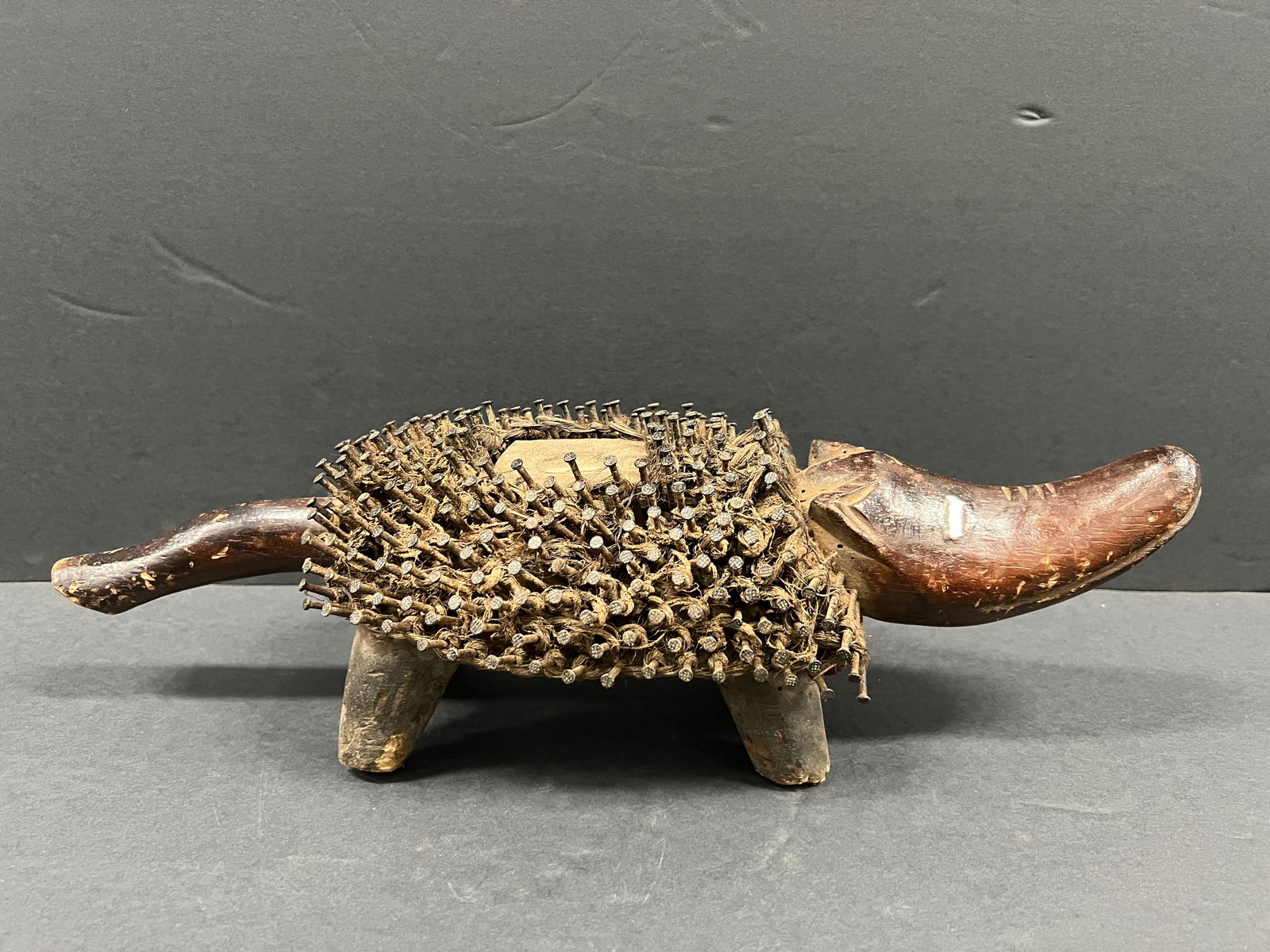 Bacongo Dog Nail Fetish Statue: African Tribal Art Carved Wood Bacongo Dog Nail Fetsih Statue. The dimension is 5 inches high x 16.5 inches wide. Please be aware that some of the items are vintage, secondhand, old ages, antiques