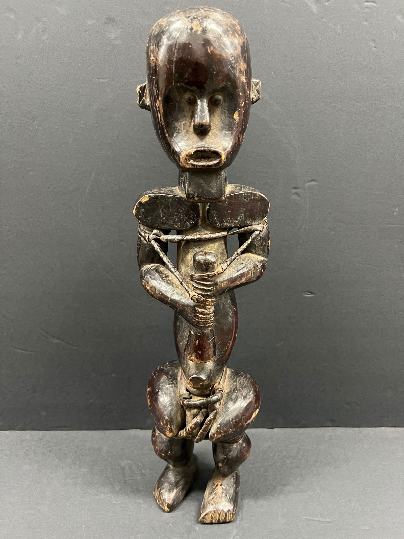 Fang Statue: African Tribal Art Carved Wood Fang Statue. The dimension is 21.5 inches high x 4.5 inches wide. Please be aware that some of the items are vintage, secondhand, old ages, antiques and may have a