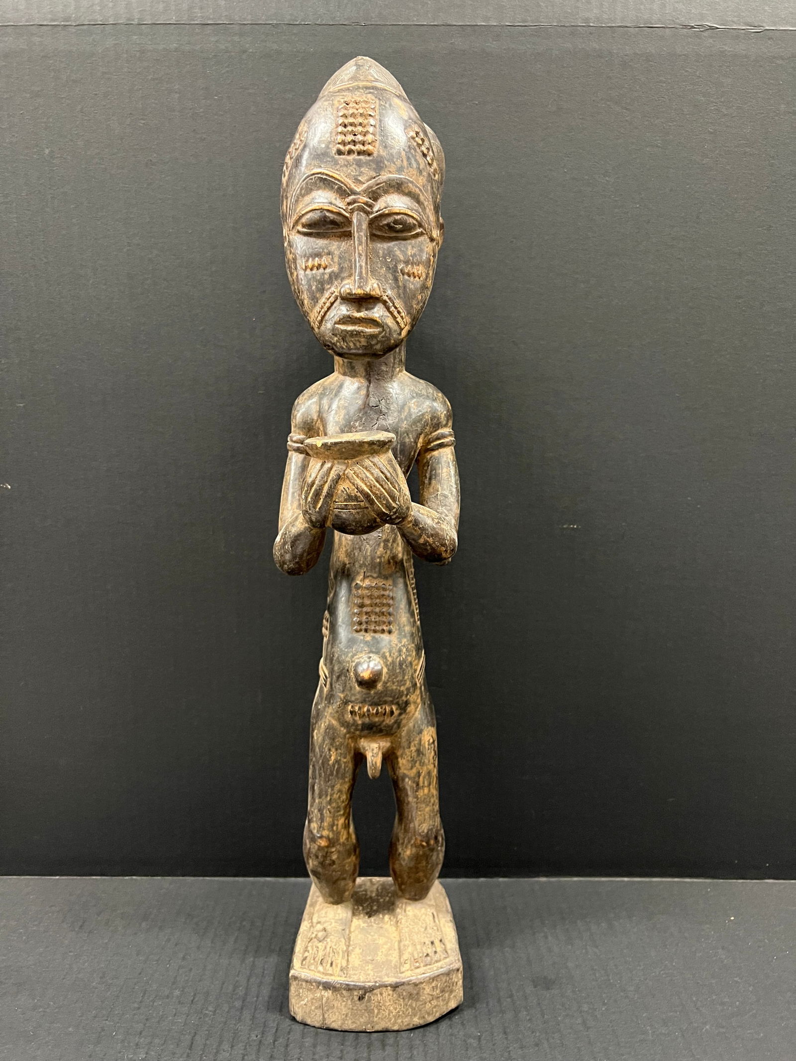 Baule Statue: African Tribal Art Carved Wood Baule Statue. The dimension is 22 inches high x 6 inches wide. Please be aware that some of the items are vintage, secondhand, old ages, antiques and may have a defects