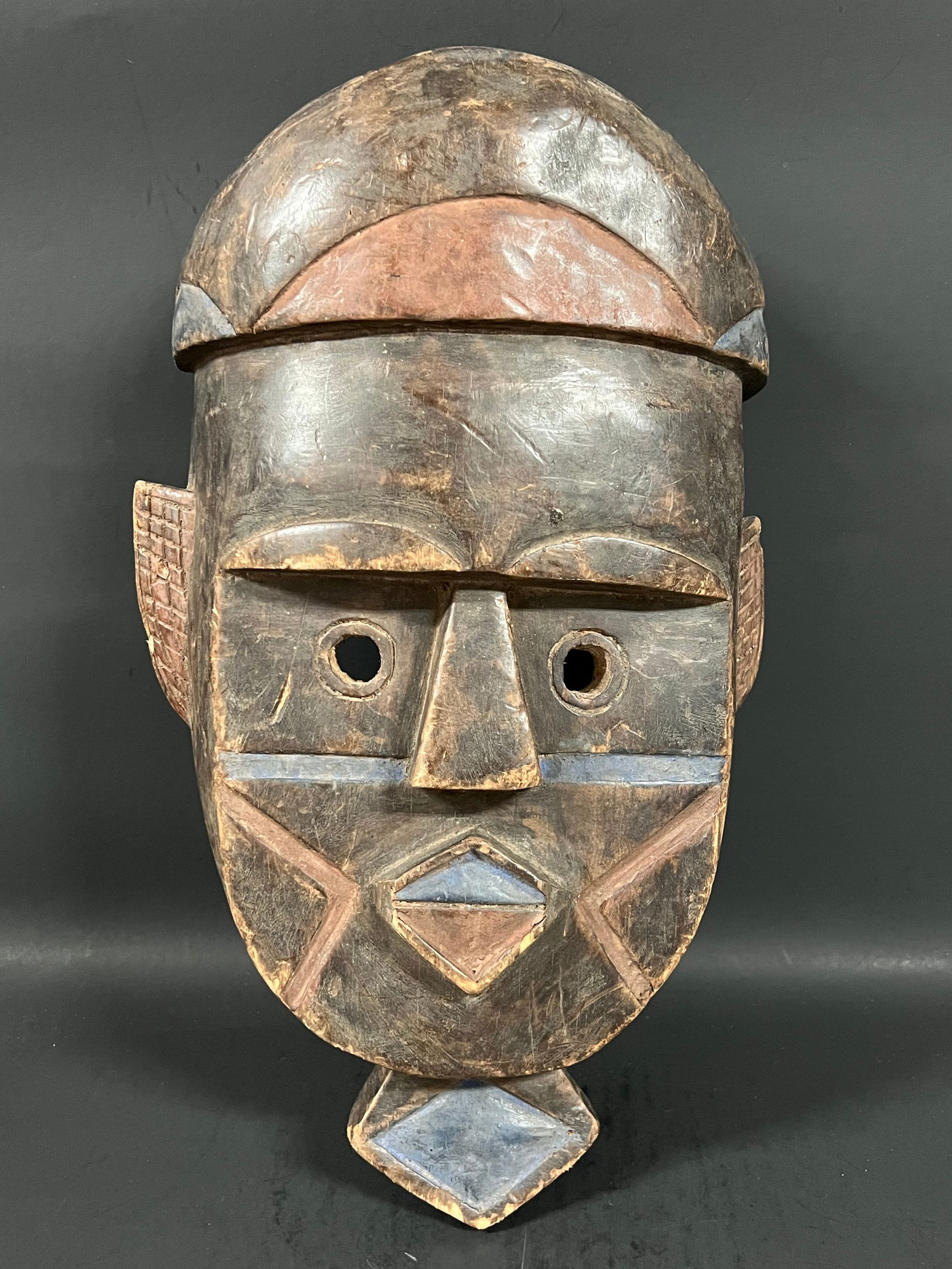 Toma Mask: African Tribal Art Carved Wood Toma Mask. The dimension is 15.5 inches high x 9 inches wide. Please be aware that some of the items are vintage, secondhand, old ages, antiques and may have a defects