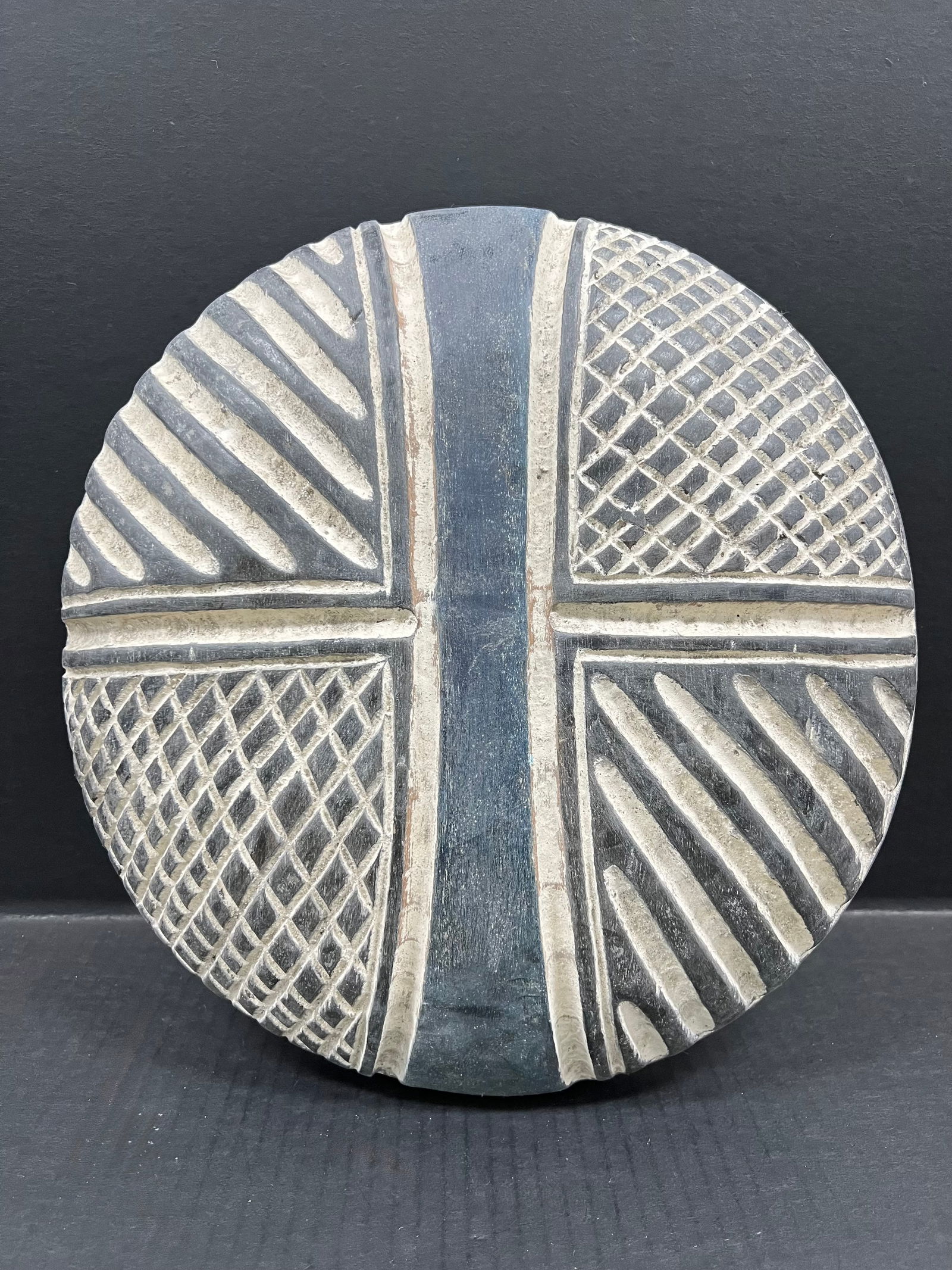 Zulu Shield: African Tribal Art Carved Wood Zulu Shield. The dimension is 13.5 inches high x 13.5 inches wide. Please be aware that some of the items are vintage, secondhand, old ages, antiques and may have a defe