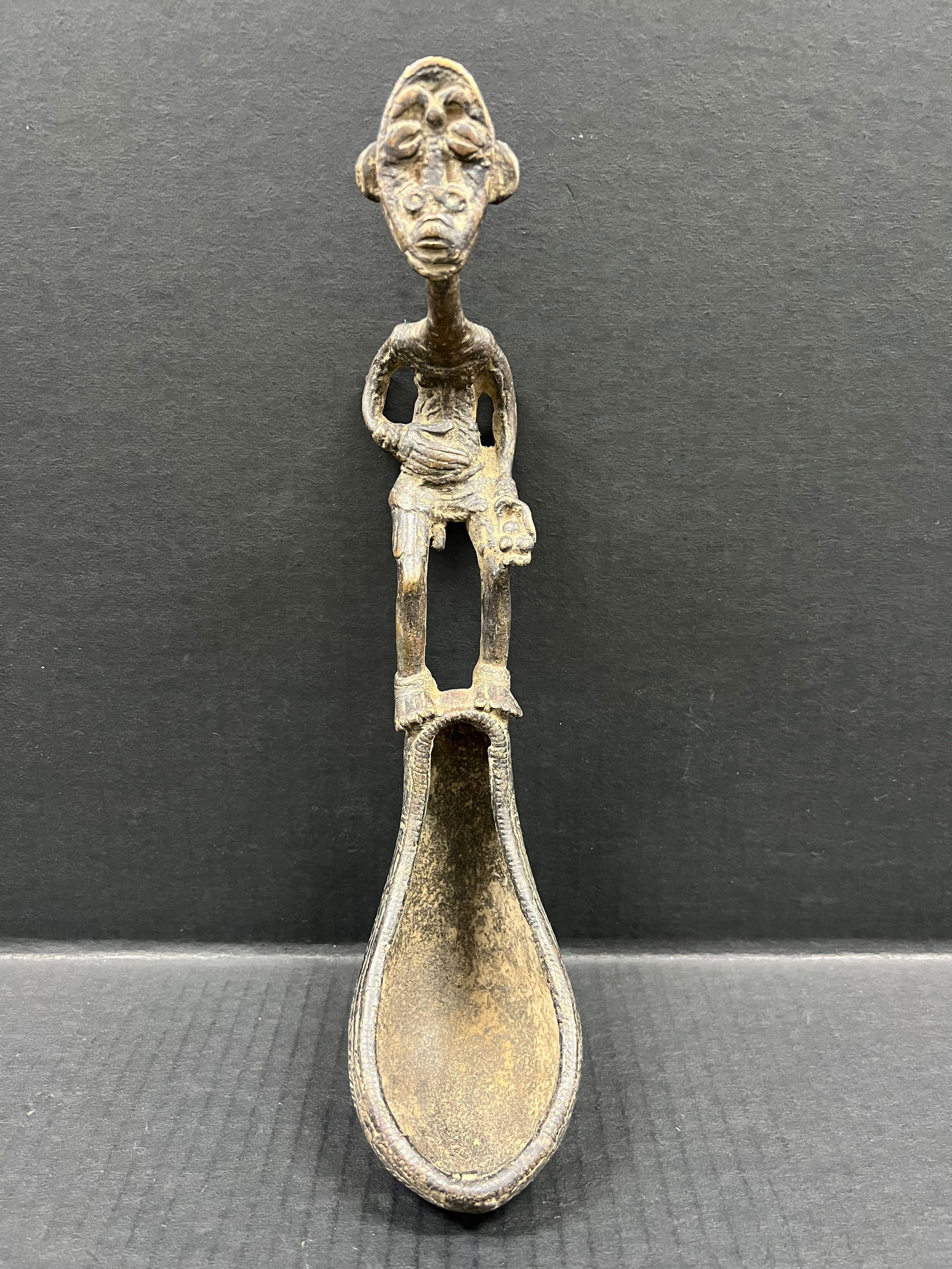Dogon Bronze Spoon: African Tribal Art Dogon Bronze Spoon. The dimension is 12.5 inches high x 3 inches wide. Please be aware that some of the items are vintage, secondhand, old ages, antiques and may have a defects or s