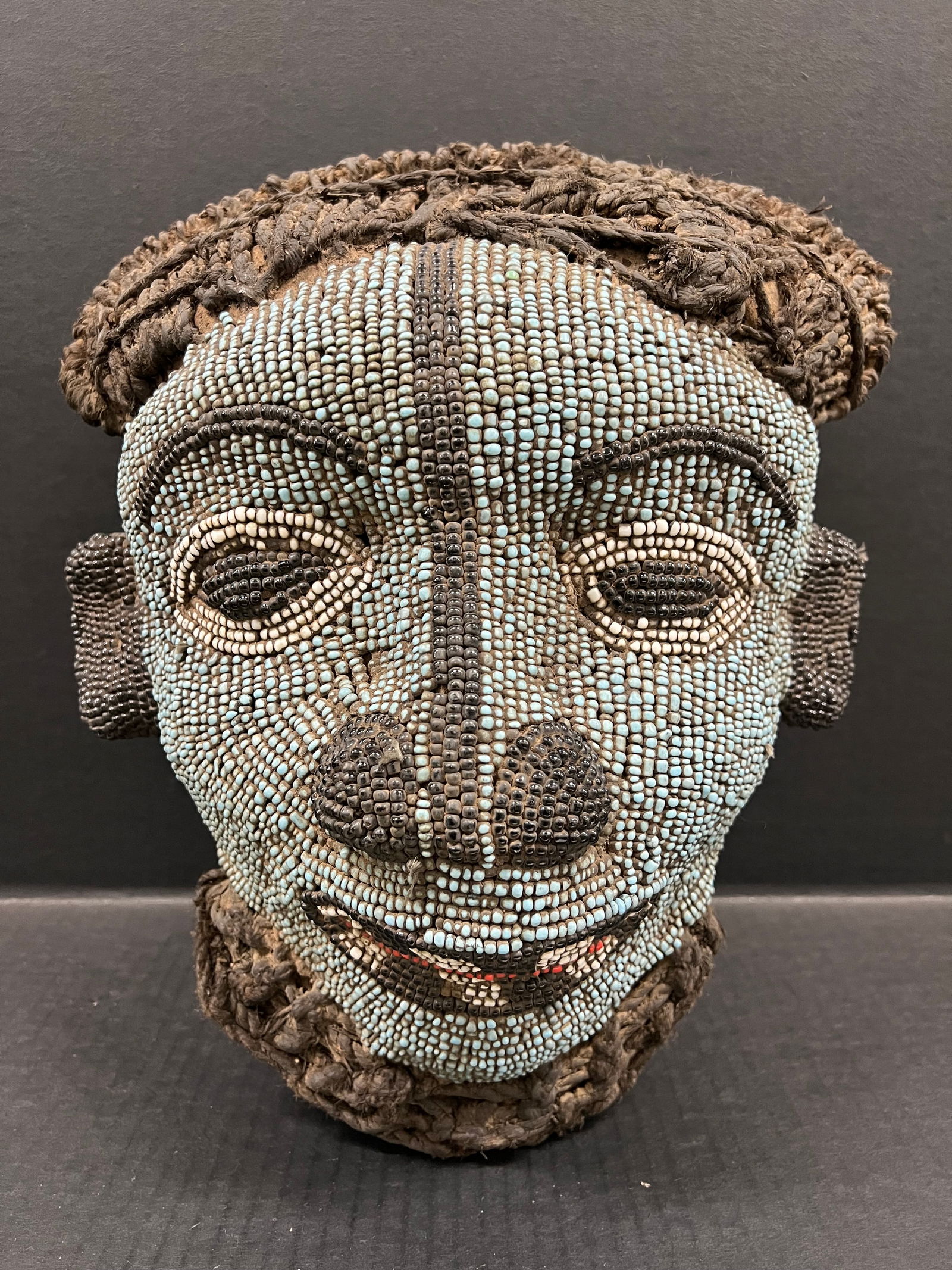 Bamileke Beaded Mask: African Tribal Art Carved Wood Bamileke Beaded Mask. The dimension is 15 inches high x 13 inches wide. Please be aware that some of the items are vintage, secondhand, old ages, antiques and may have