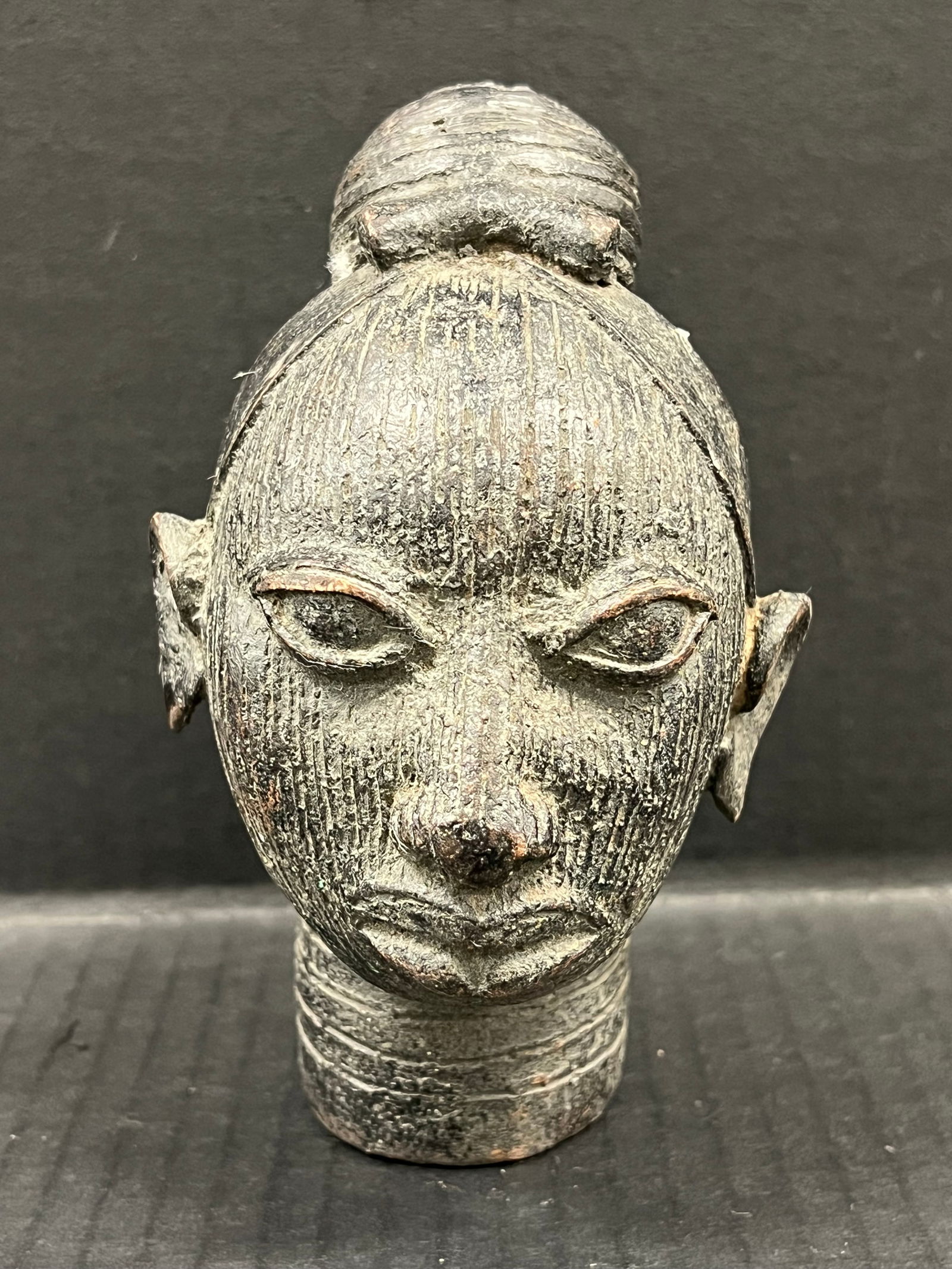 Benin Bronze Head Sculpture: African Tribal Art Benin Bronze Head Sculpture. The dimension is 6 inches high x 4 inches depth x 3.5 inches wide. Please be aware that some of the items are vintage, secondhand, old ages, antiques