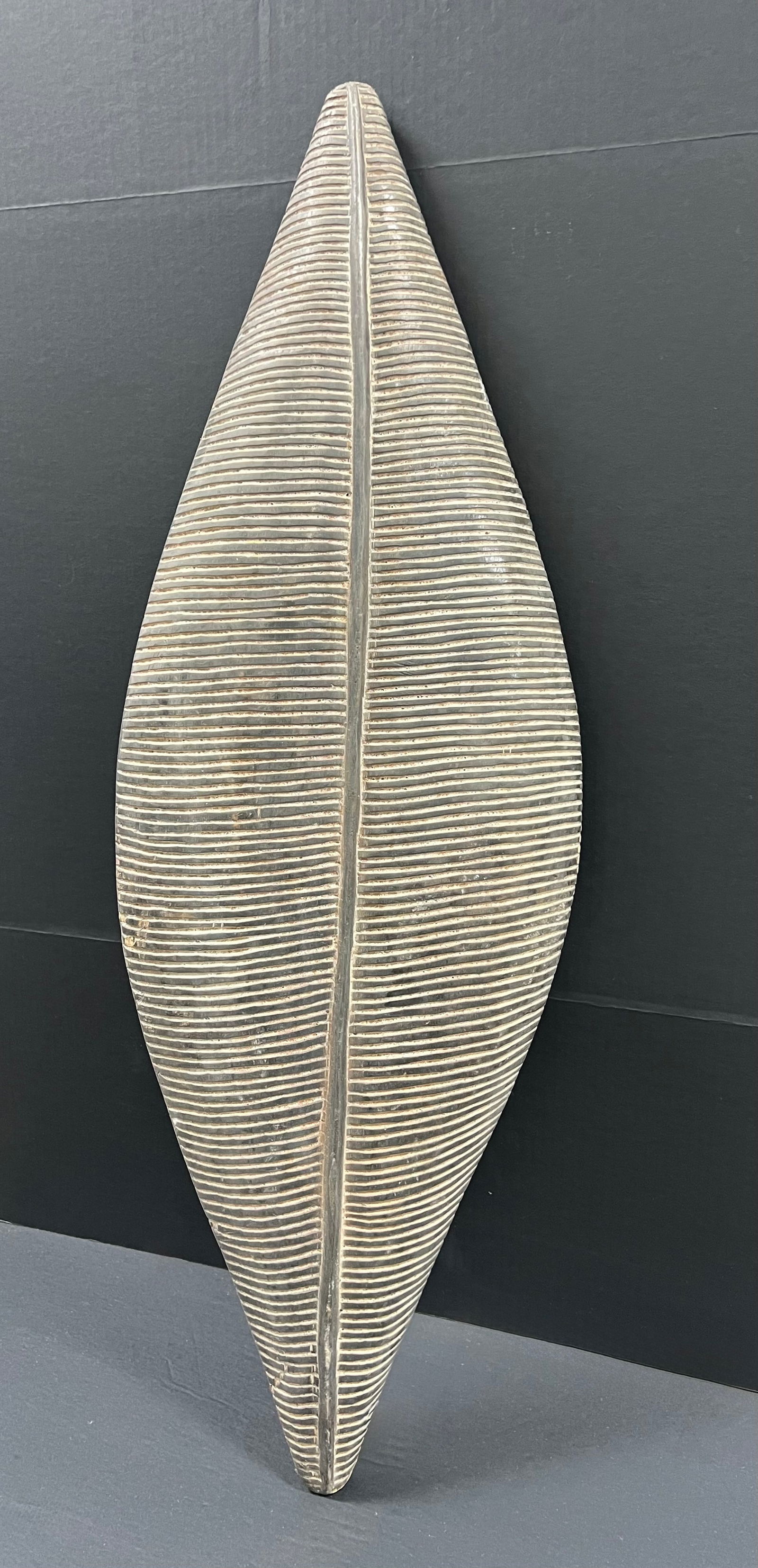 Elongated Zulu Shield: African Tribal Art Carved Wood Elongated Zulu Shield. The dimension is 39 inches high x 13 inches wide. Please be aware that some of the items are vintage, secondhand, old ages, antiques and may have