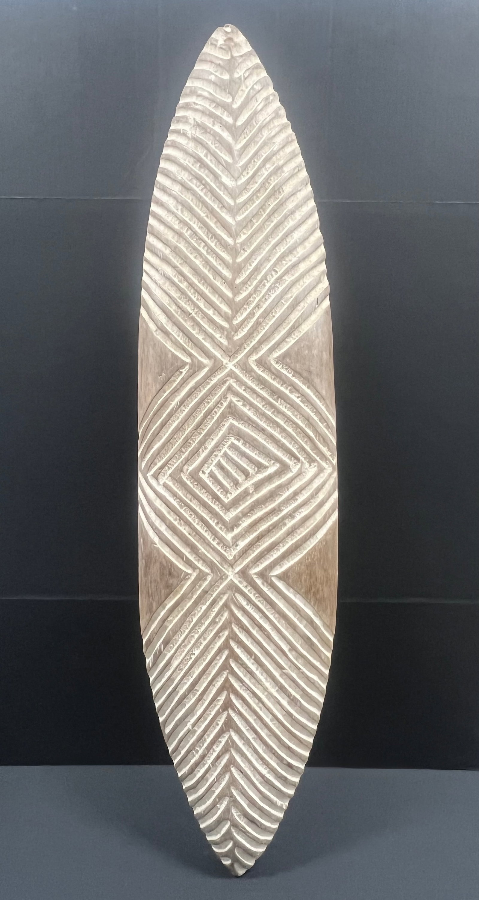Elongated Zulu Shield: African Tribal Art Carved Wood Elongated Zulu Shield. The dimension is 45 inches high x 11 inches wide. Please be aware that some of the items are vintage, secondhand, old ages, antiques and may have