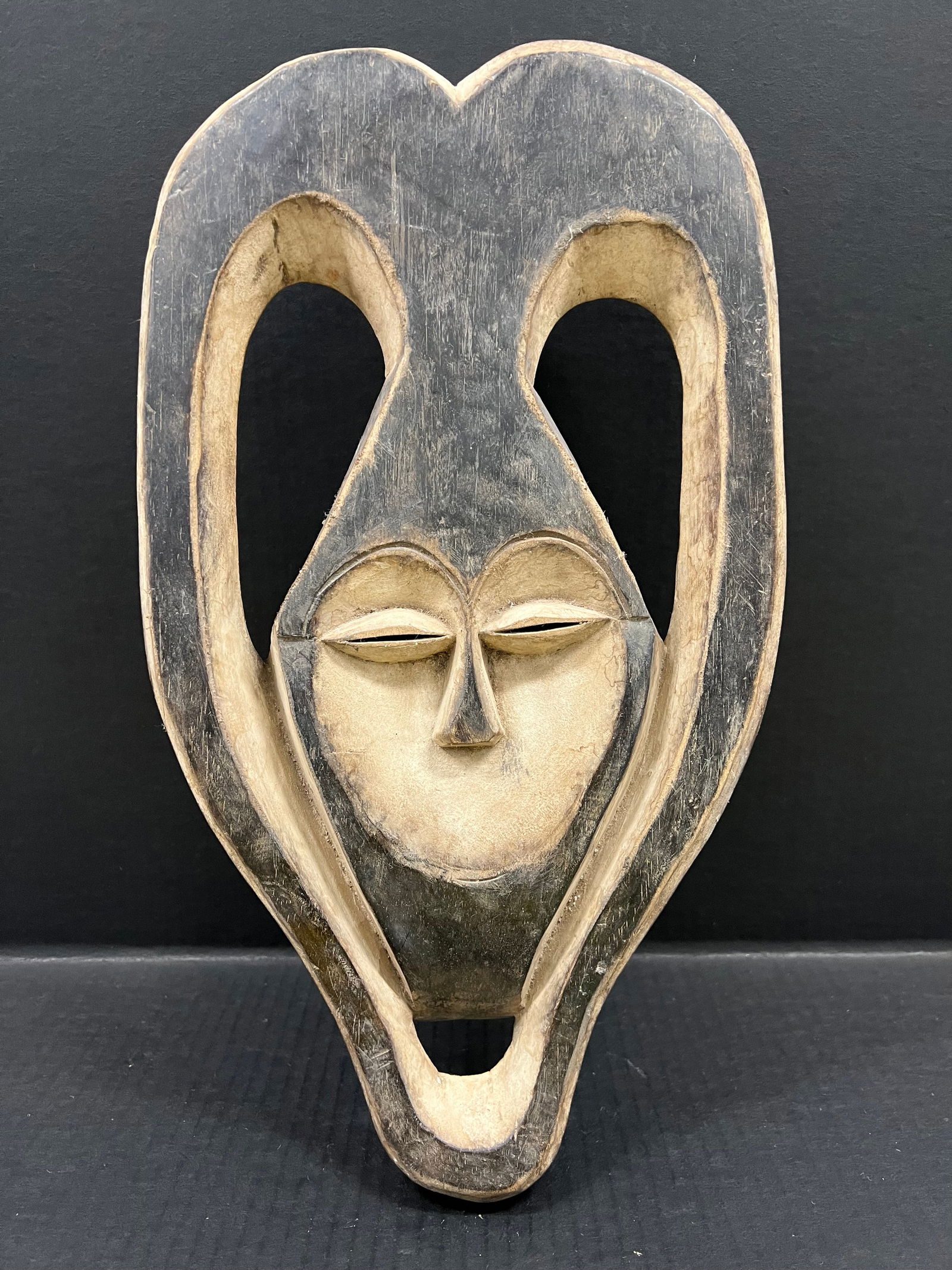 Kwele Mask: African Tribal Art Carved Wood Kwele Mask. The dimension is 17 inches high x 10 inches wide. Please be aware that some of the items are vintage, secondhand, old ages, antiques and may have a defects