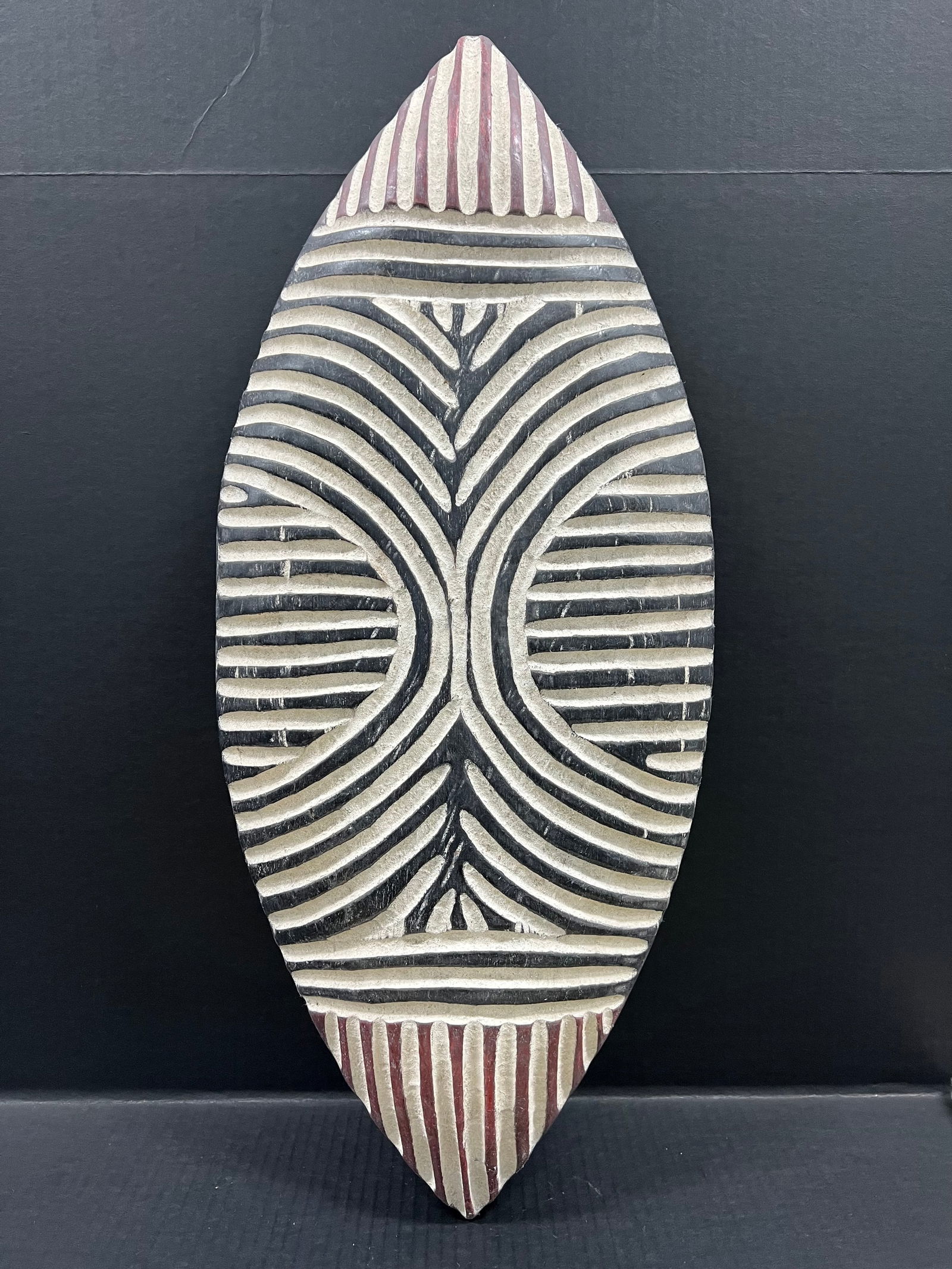 Zulu Shield: African Tribal Art Carved Wood Zulu Shield. The dimension is 27.5 inches high x 12 inches wide. Please be aware that some of the items are vintage, secondhand, old ages, antiques and may have a defect