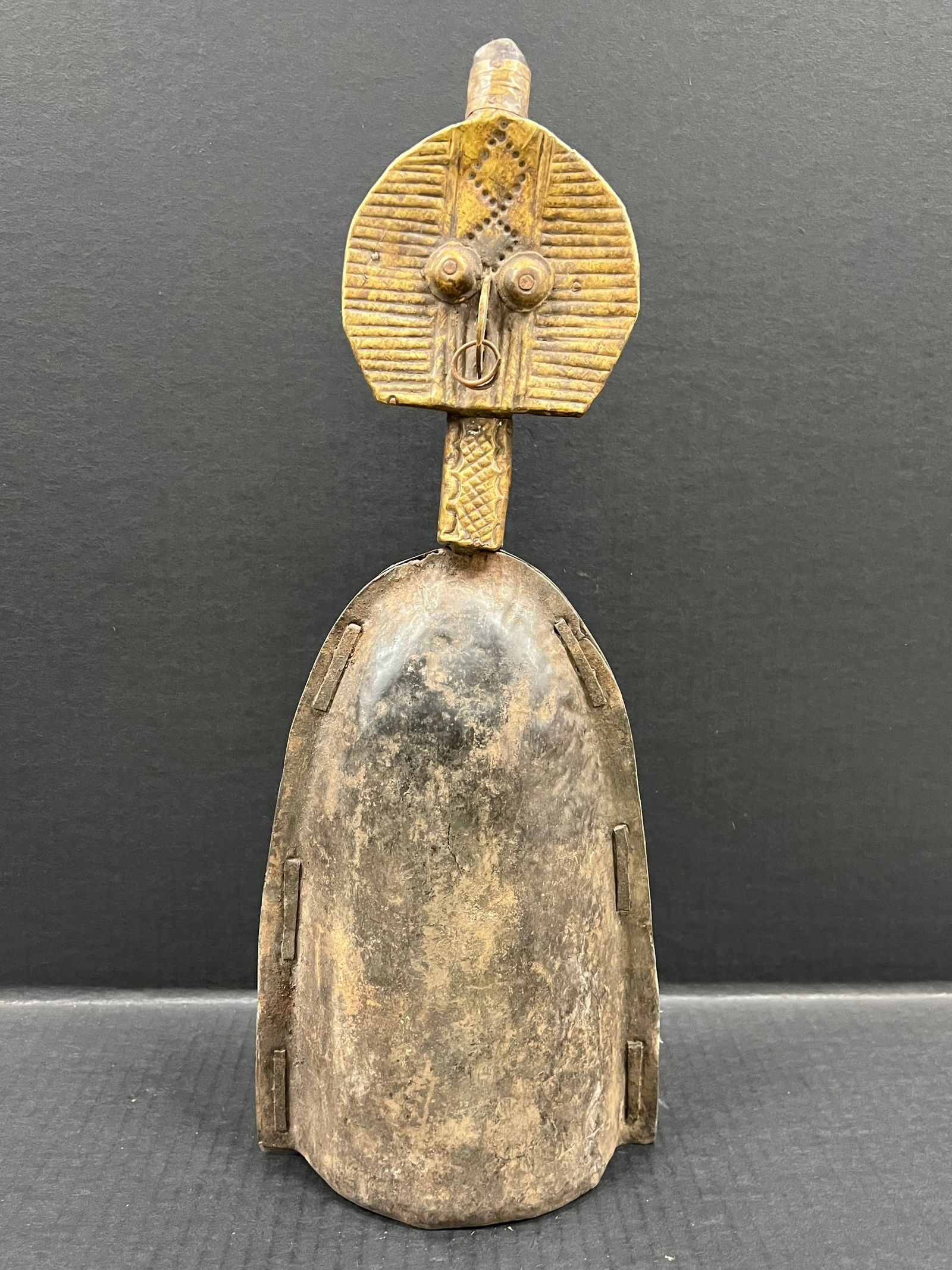 Bacota Bell: African Tribal Art Bacota Bell. The dimension is 17 inches high x 6.5 inches wide. Please be aware that some of the items are vintage, secondhand, old ages, antiques and may have a defects or sign of