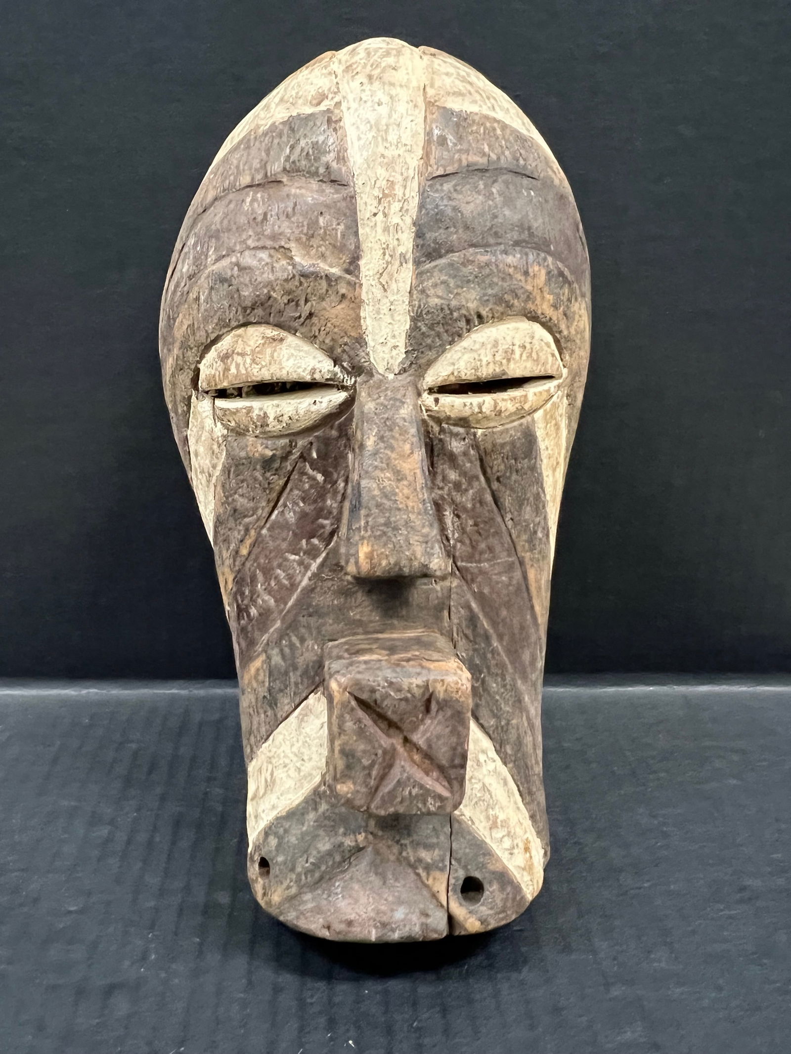 Songye Mask: African Tribal Art Carved Wood Songye Mask. The dimension is 10 inches high x 6 inches wide. Please be aware that some of the items are vintage, secondhand, old ages, antiques and may have a defects