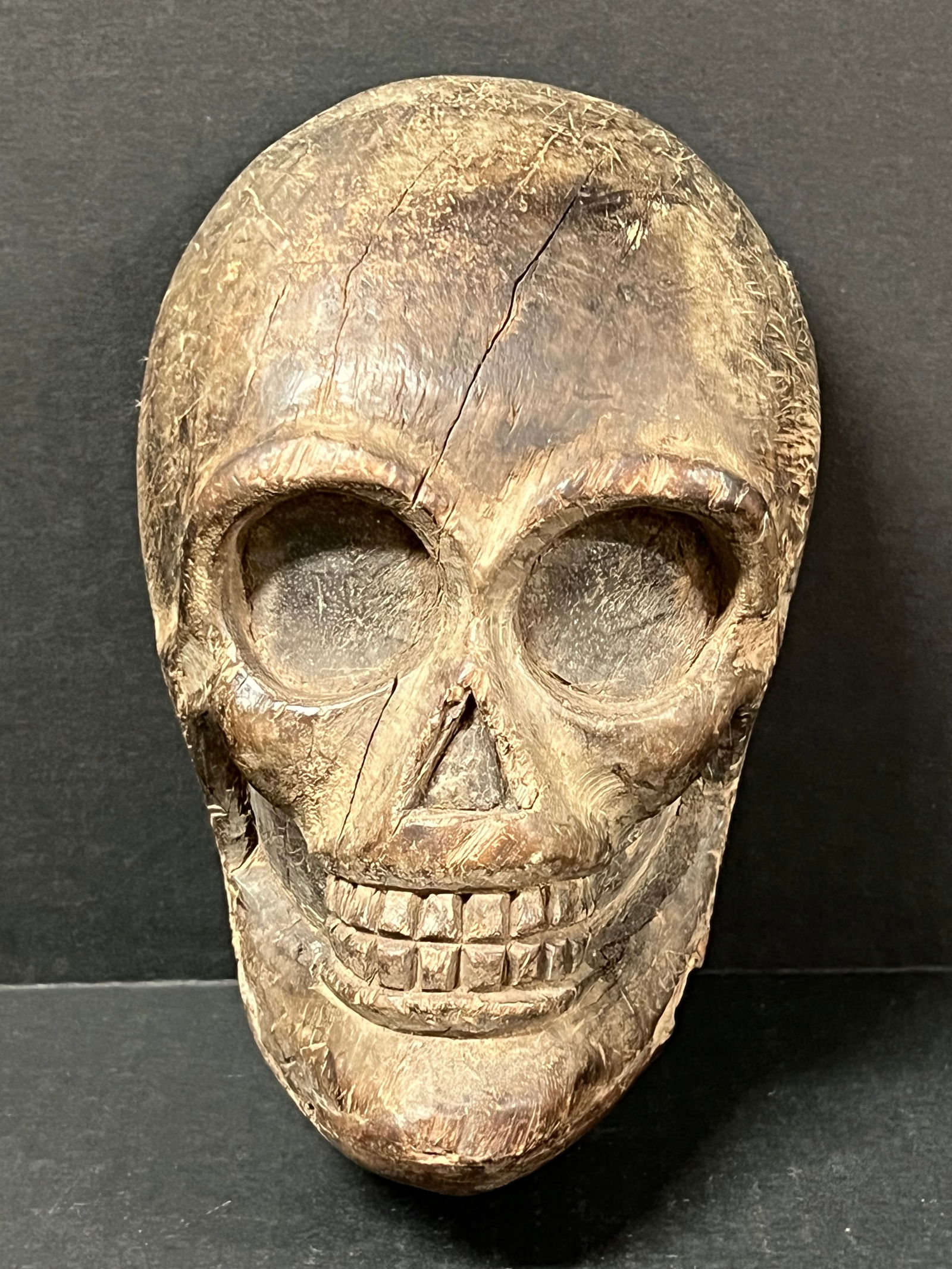 Carved Wood Skull: Folk Art Carved Wood Papermache Mold of Skull. The dimension is 8 inches high x 5 inches wide. Please be aware that some of the items are vintage, secondhand, old ages, antiques and may have a