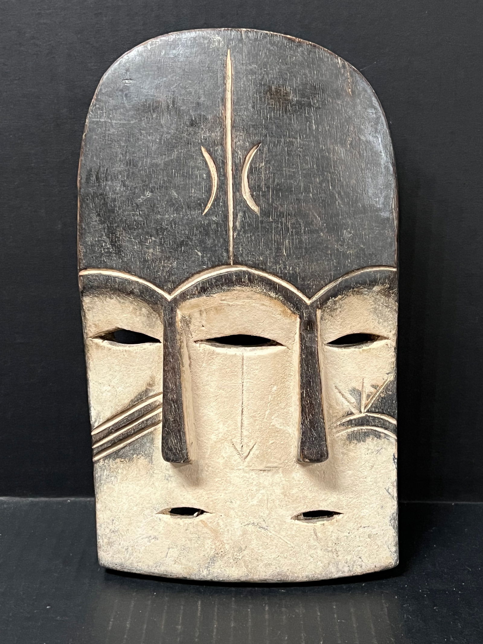 Kwele Mask: African Tribal Art Carved Wood Kwele Mask. The dimension is 10.5 inches high x 6.5 inches wide. Please be aware that some of the items are vintage, secondhand, old ages, antiques and may have a