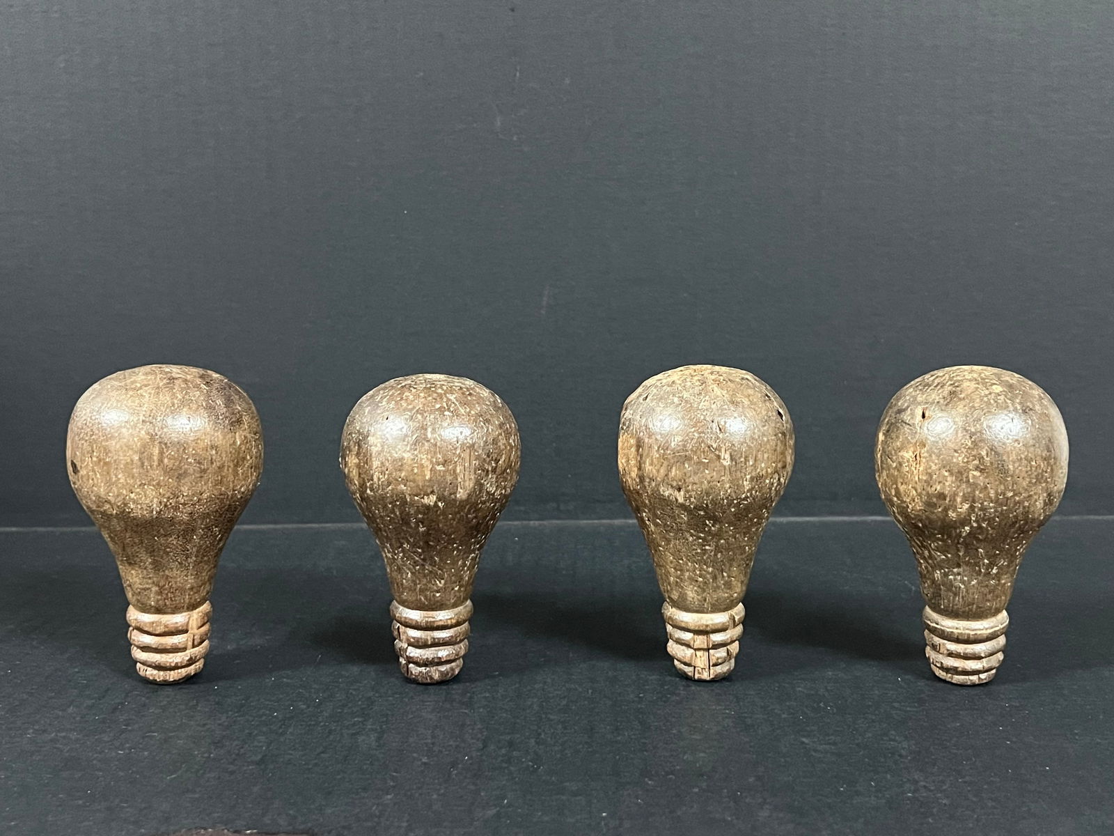 Carved Wood Bulb set of 4: Folk Art Carved Wood Papermache Mold of Bulb. The dimension is 4 inches high x 2.5 inches wide. Please be aware that some of the items are vintage, secondhand, old ages, antiques and may have a