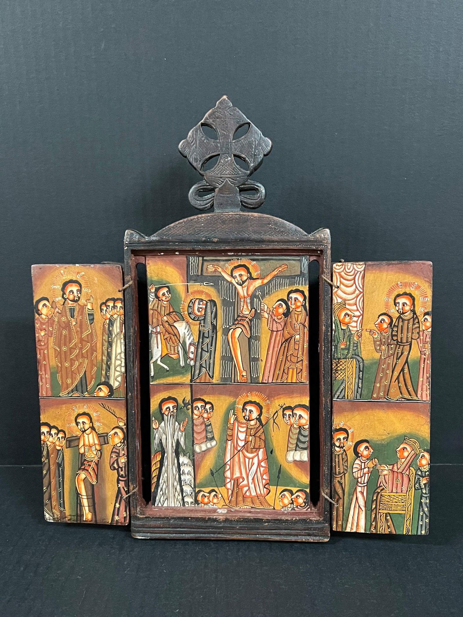 Carved Wood Ethiopian Painted Icon: African Tribal Art Carved Wood Ethiopian Painted Icon. The dimension is 13 inches high x 11.75 inches wide. Please be aware that some of the items are vintage, secondhand, old ages, antiques and may