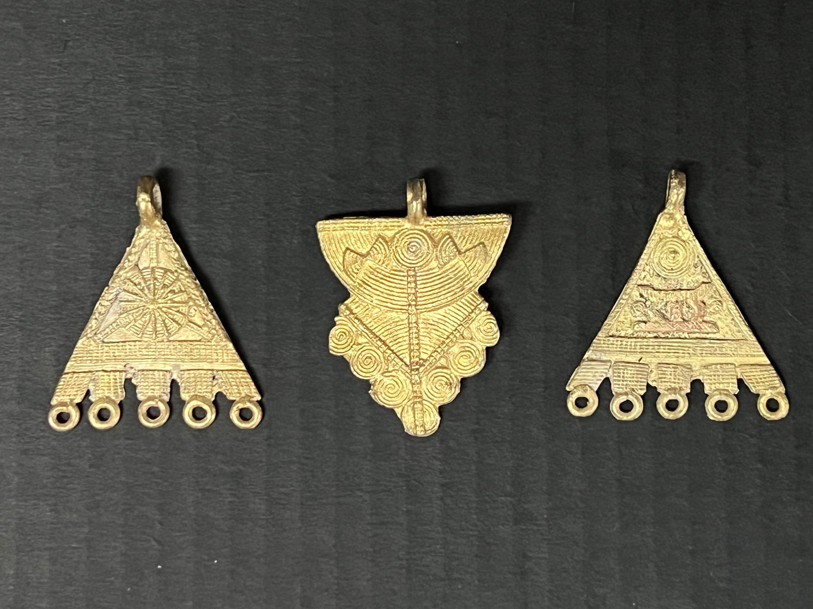 Ashanti Brass Pendant Set of 3: African Tribal Art Ashanti Brass Pendant. The dimension is 2.5 inches high x 2 inches wide. Please be aware that some of the items are vintage, secondhand, old ages, antiques and may have a defects or