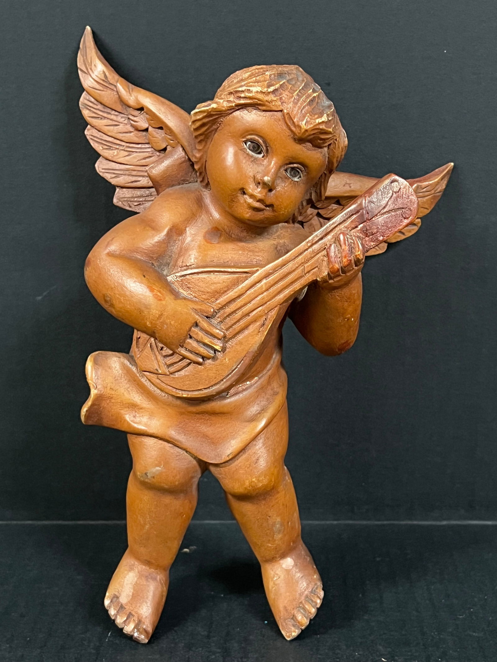 Carved Wood Angel Playing Instrument: Religious Art Carved Wood Angel playing instrument. The dimension is 11 inches high x 7.5 inches wide. Please be aware that some of the items are vintage, secondhand, old ages, antiques and may have