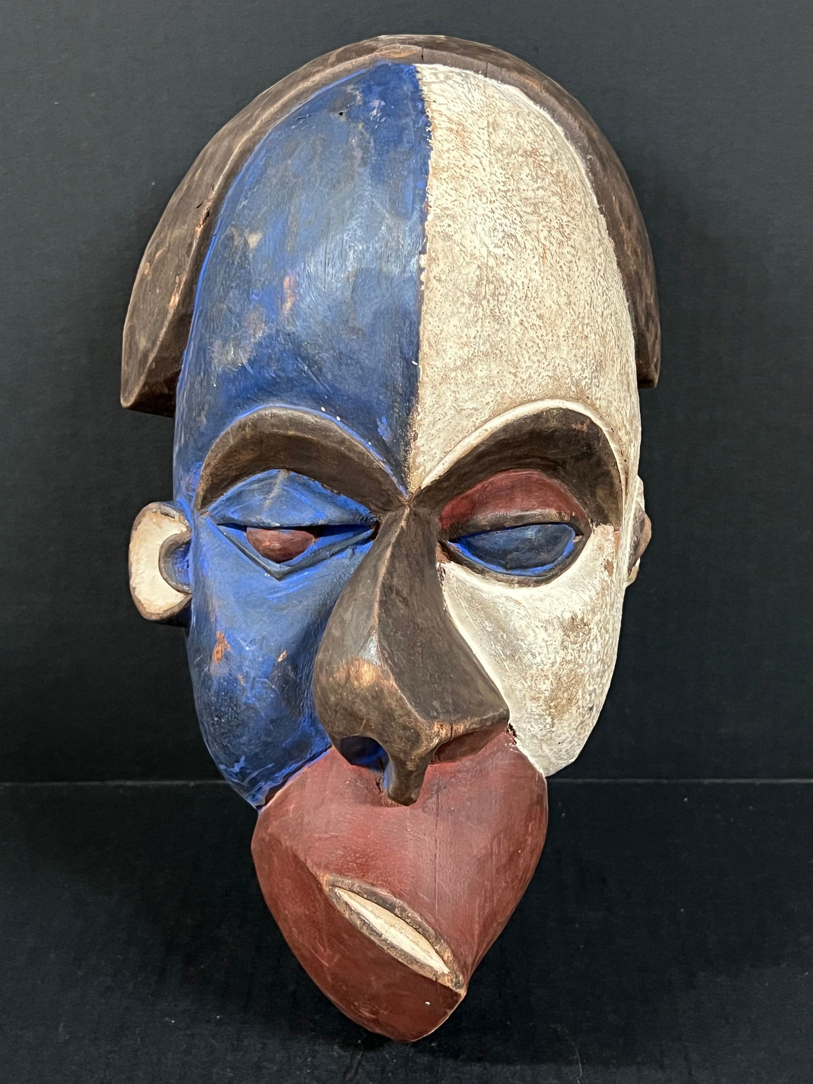 Pende Mask: African Tribal Art Pende Mask. The dimension is 13.5 inches high x 8 inches wide. Please be aware that some of the items are vintage, secondhand, old ages, antiques and may have a defects or sign of a