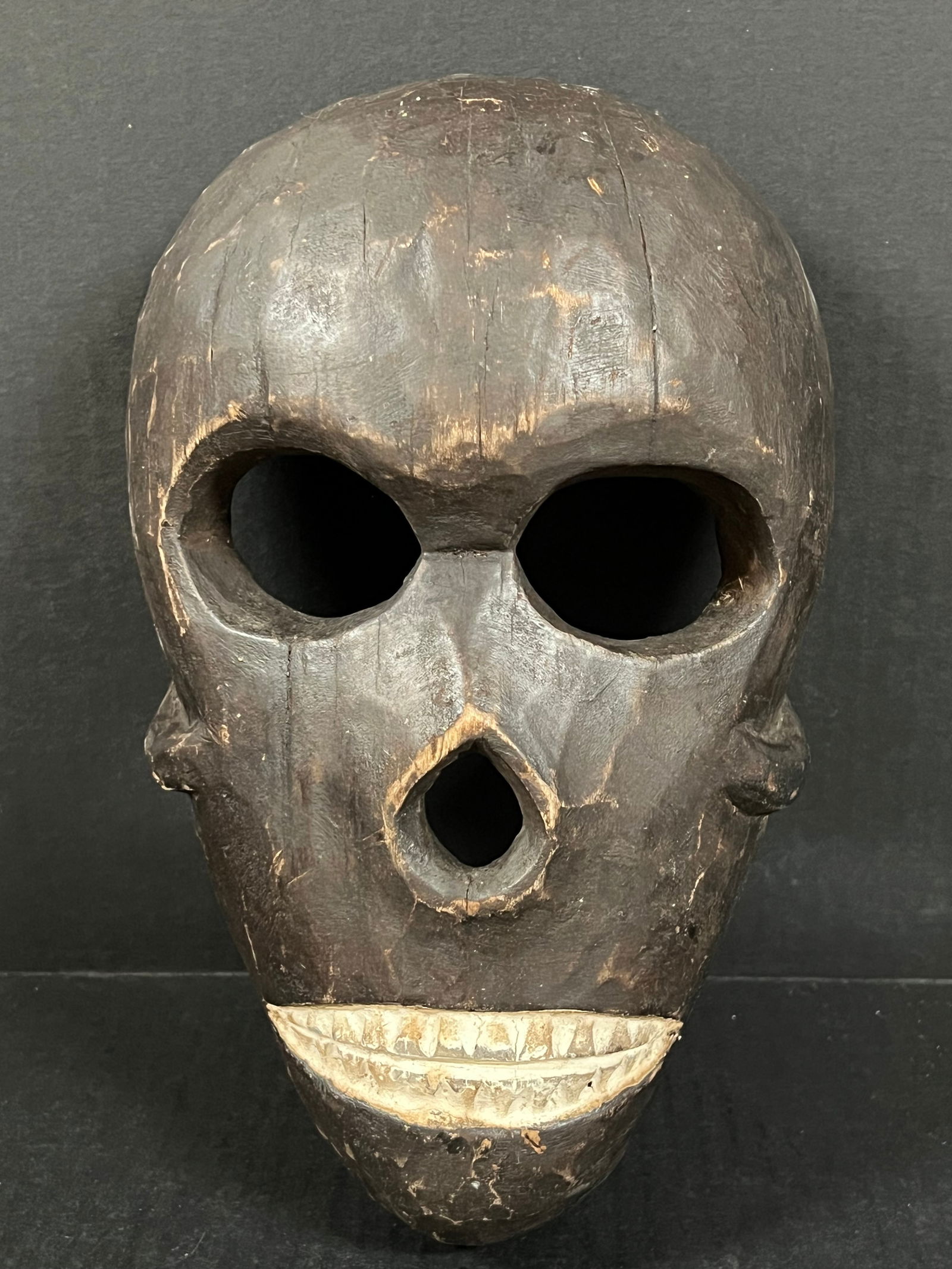Skull Mask: African Tribal Art Carved Wood Skull Mask. The dimension is 11.25 inches high x 7.25 inches wide. Please be aware that some of the items are vintage, secondhand, old ages, antiques and may have a
