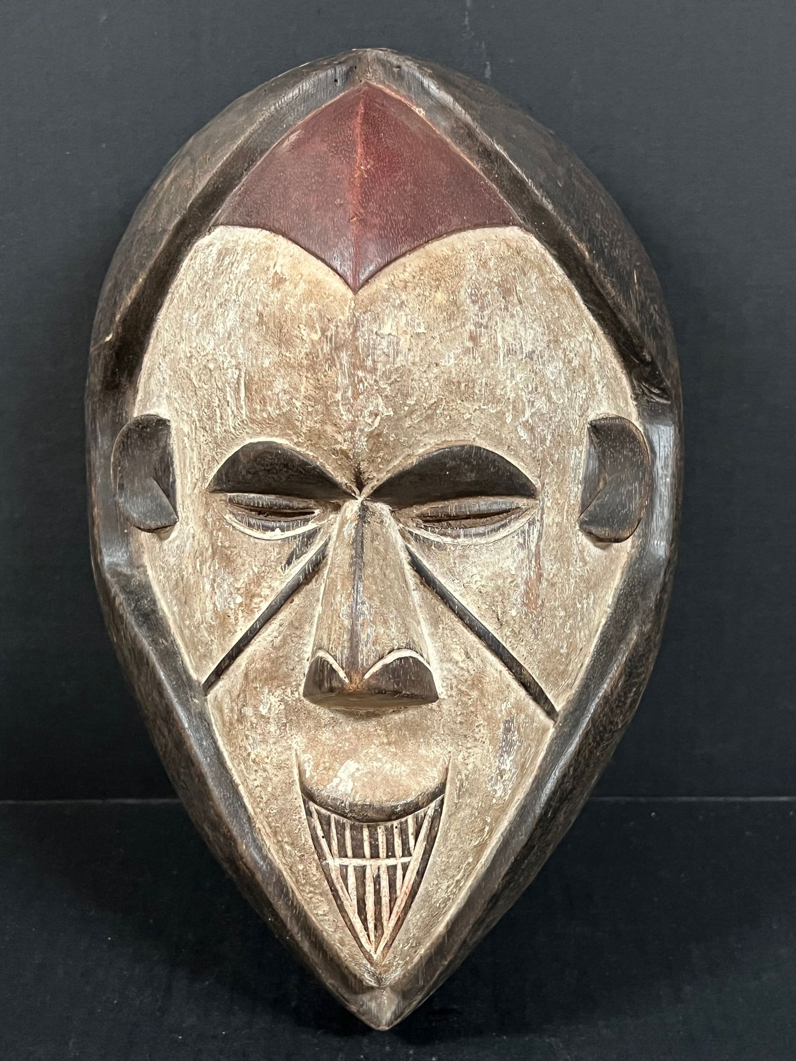 Ibo Mask: African Tribal Art Carved Wood Ibo Mask. The dimension is 13.5 inches high x 9 inches wide. Please be aware that some of the items are vintage, secondhand, old ages, antiques and may have a defects or