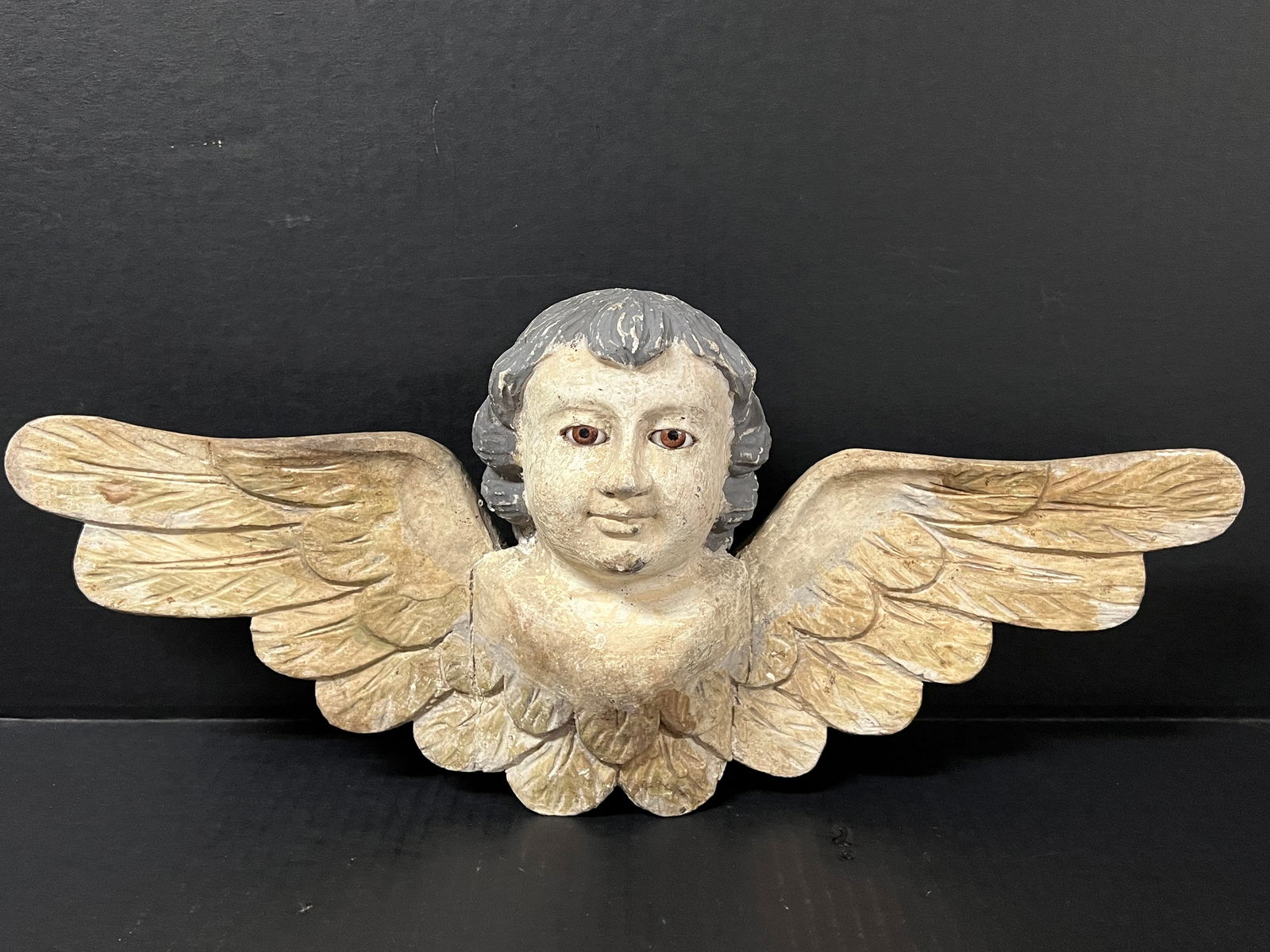Carved Wood Cherub with Long Wings and Glass Eyes: Religious Art Carved Wood Cherub with Long Wings and Glass Eyes. The dimension is 8.5 inches high x 20 inches wide. Please be aware that some of the items are vintage, secondhand, old ages, antiques