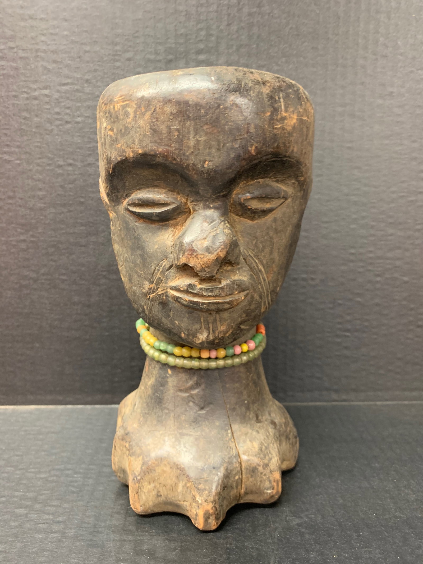 Fang Head: African Tribal Art Carved Wood Fang Head. The dimension is 9.5 inches high x 4.75 inches wide. Please be aware that some of the items are vintage, secondhand, old ages, antiques and may have a defects